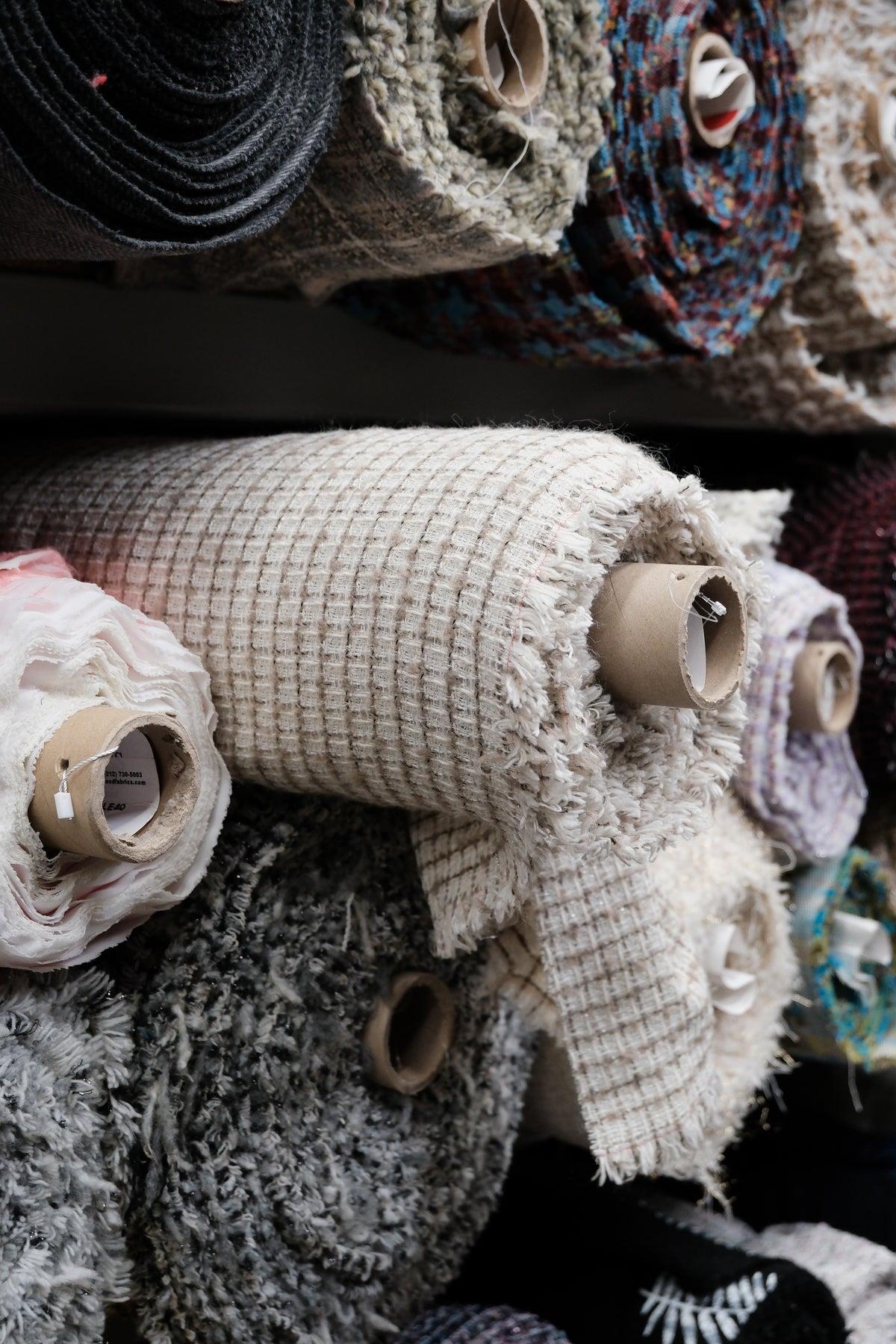 Rolls of textured deadstock fabric chosen for KUNSTEN clogs