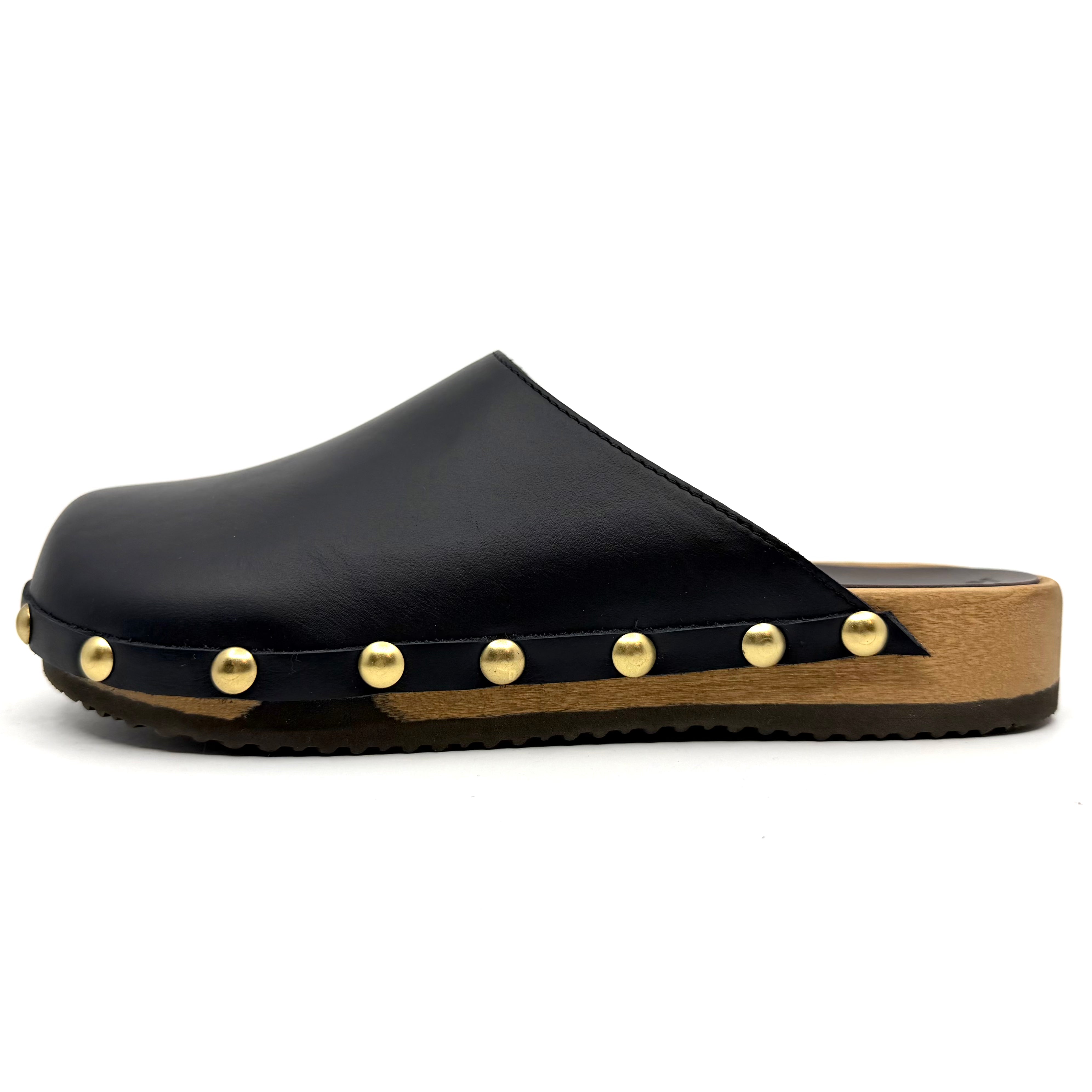 Black clog shoe with gold studs on a white background