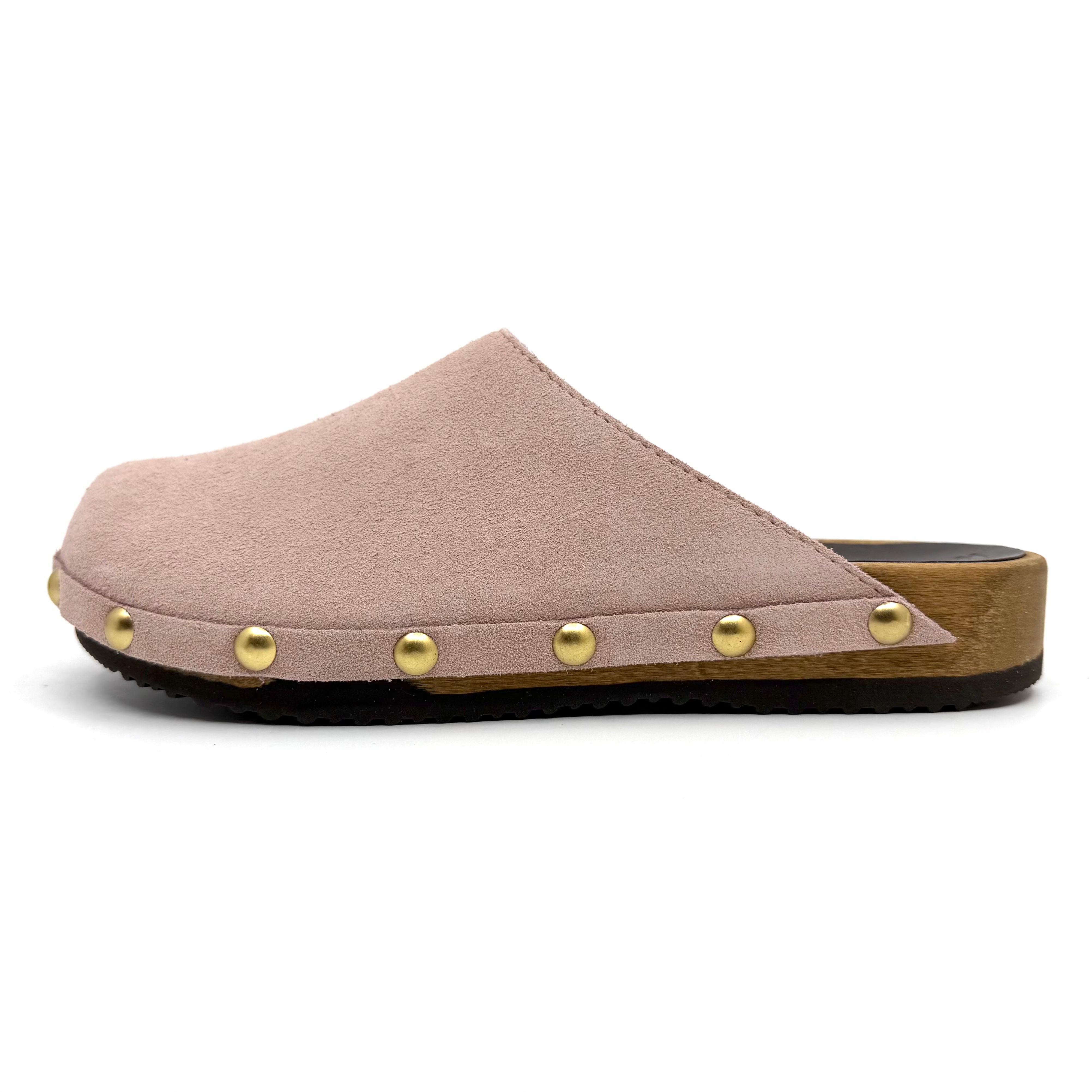 Pink clog shoe with gold studs on a white background