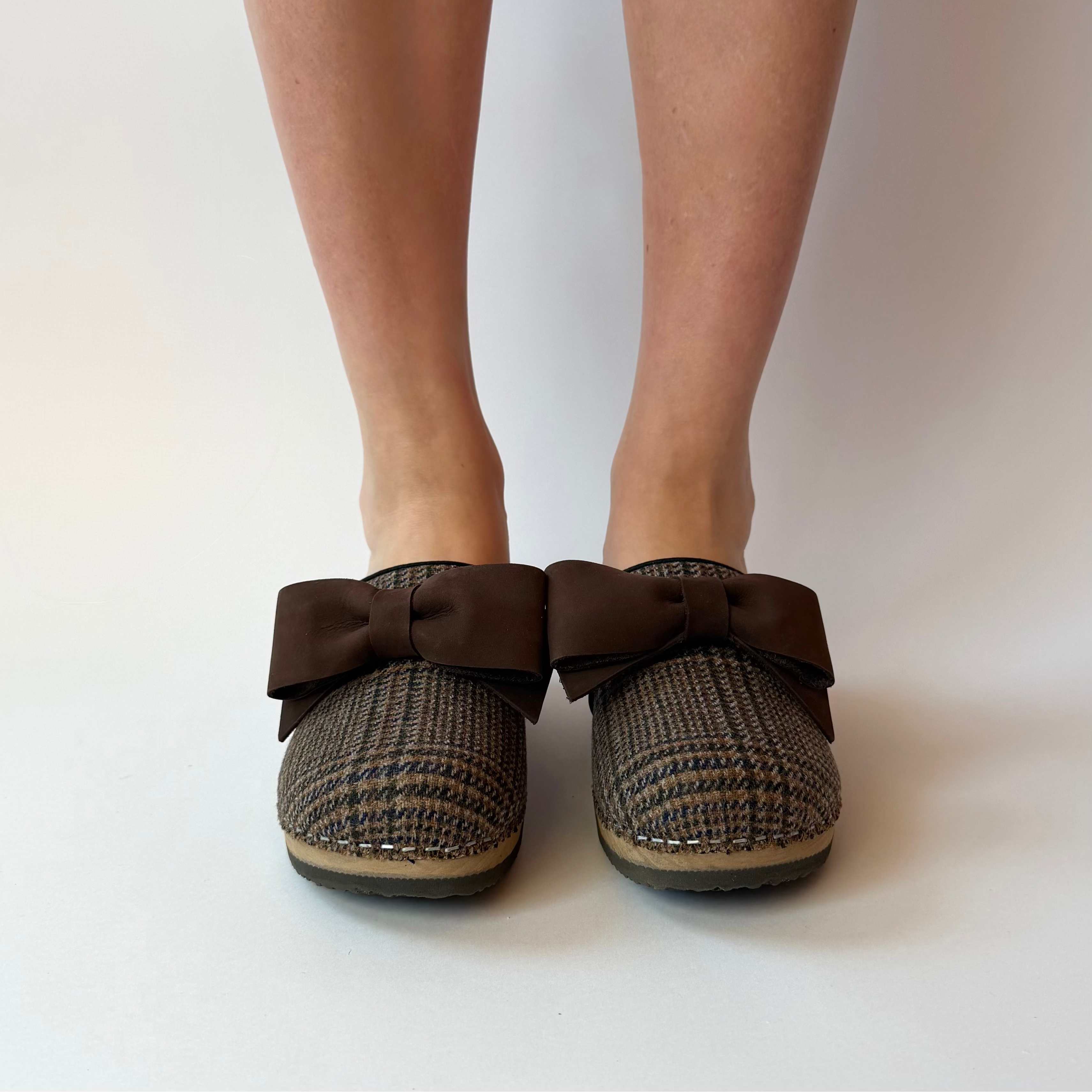 Pair of slippers with a bow on a white background