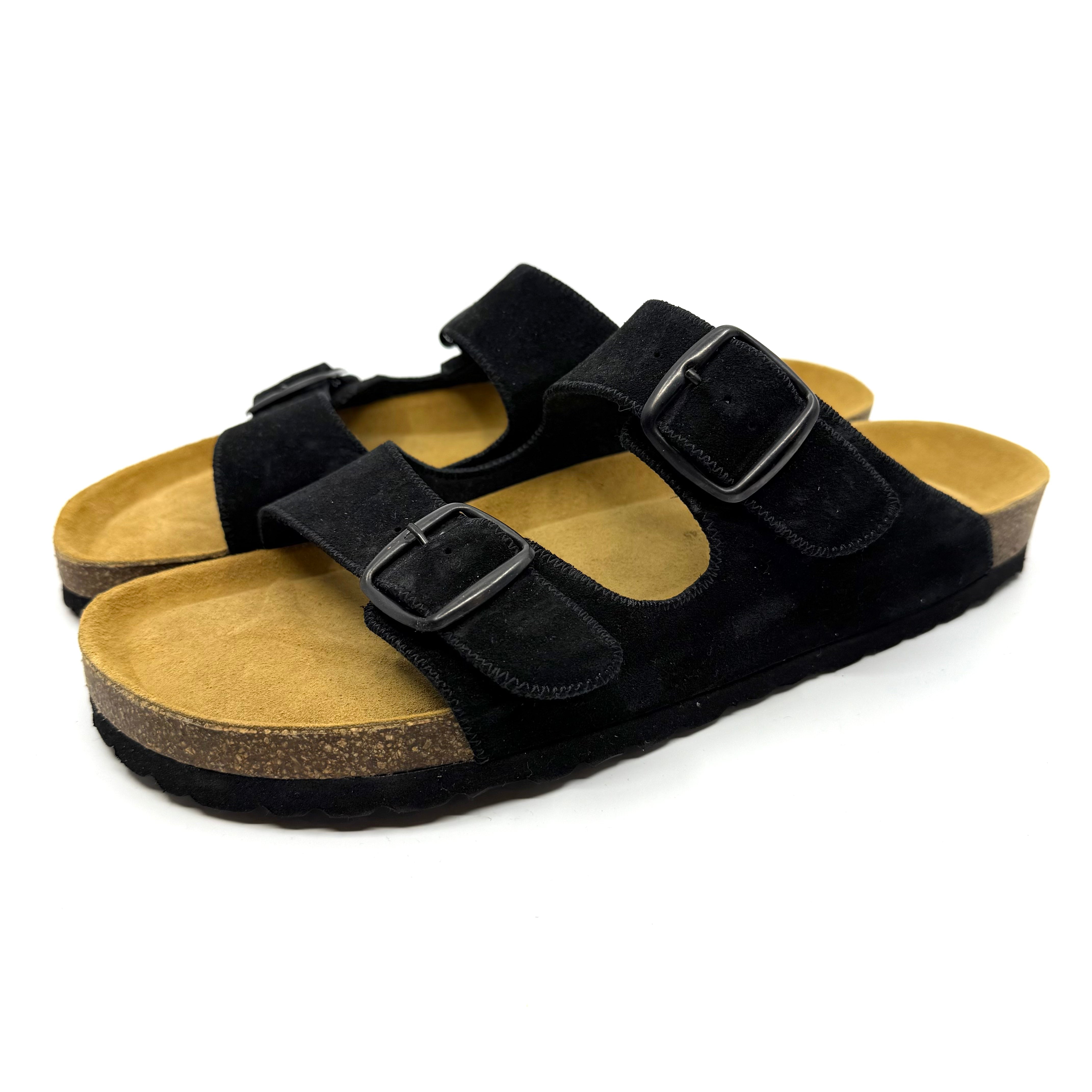 Black sandals with cork soles on a white background