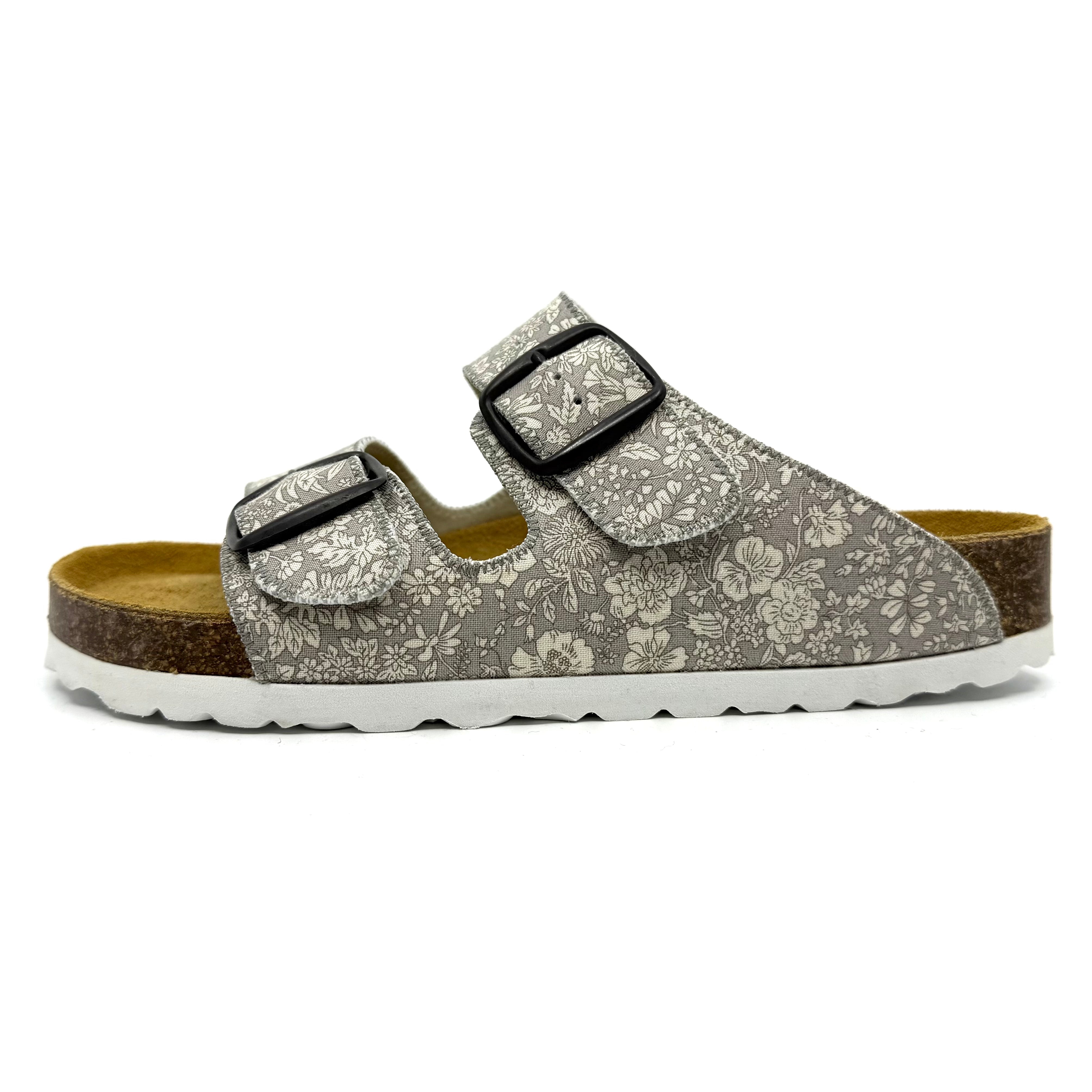 Floral patterned sandal with two buckles on a white background