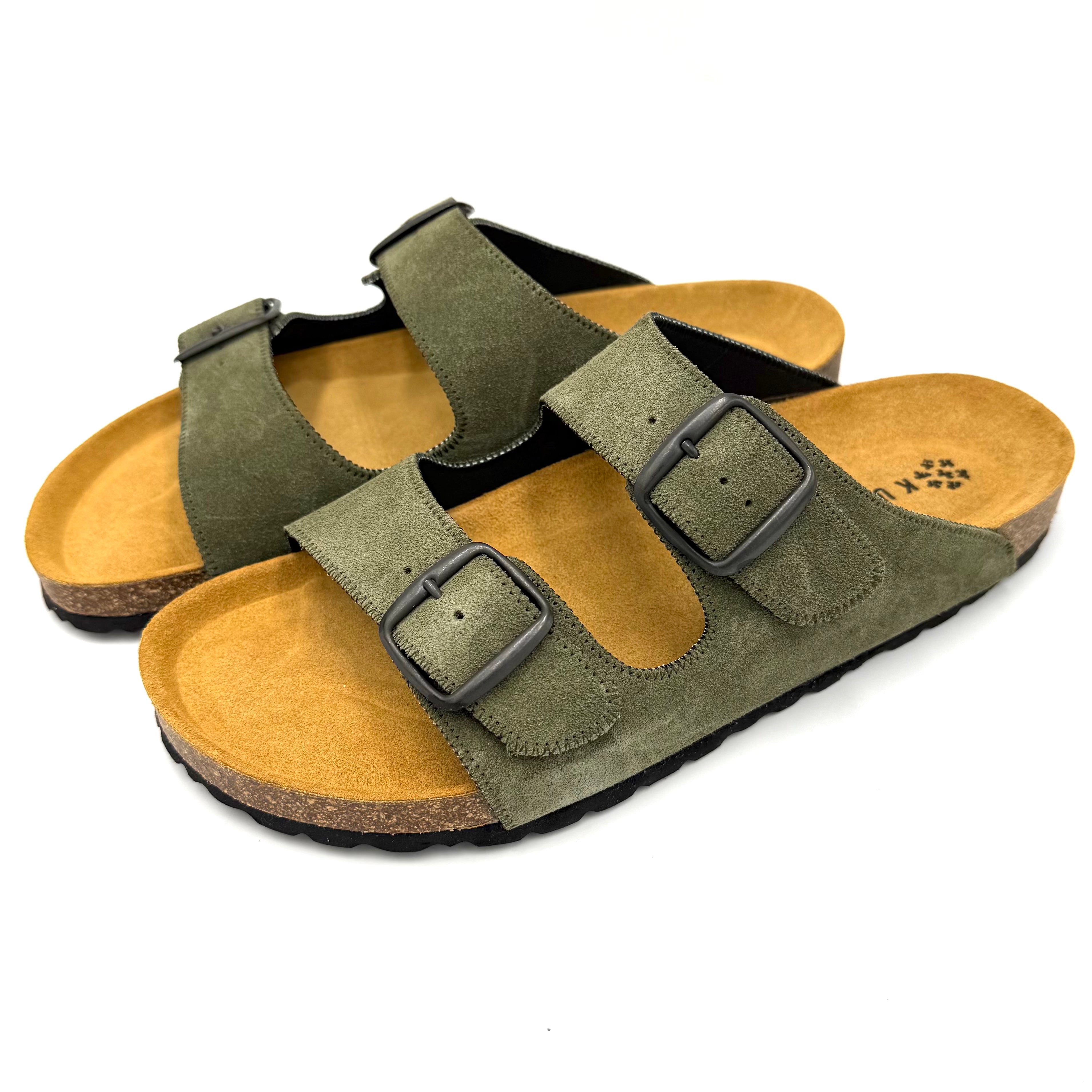 Pair of green suede sandals with brown soles on a white background