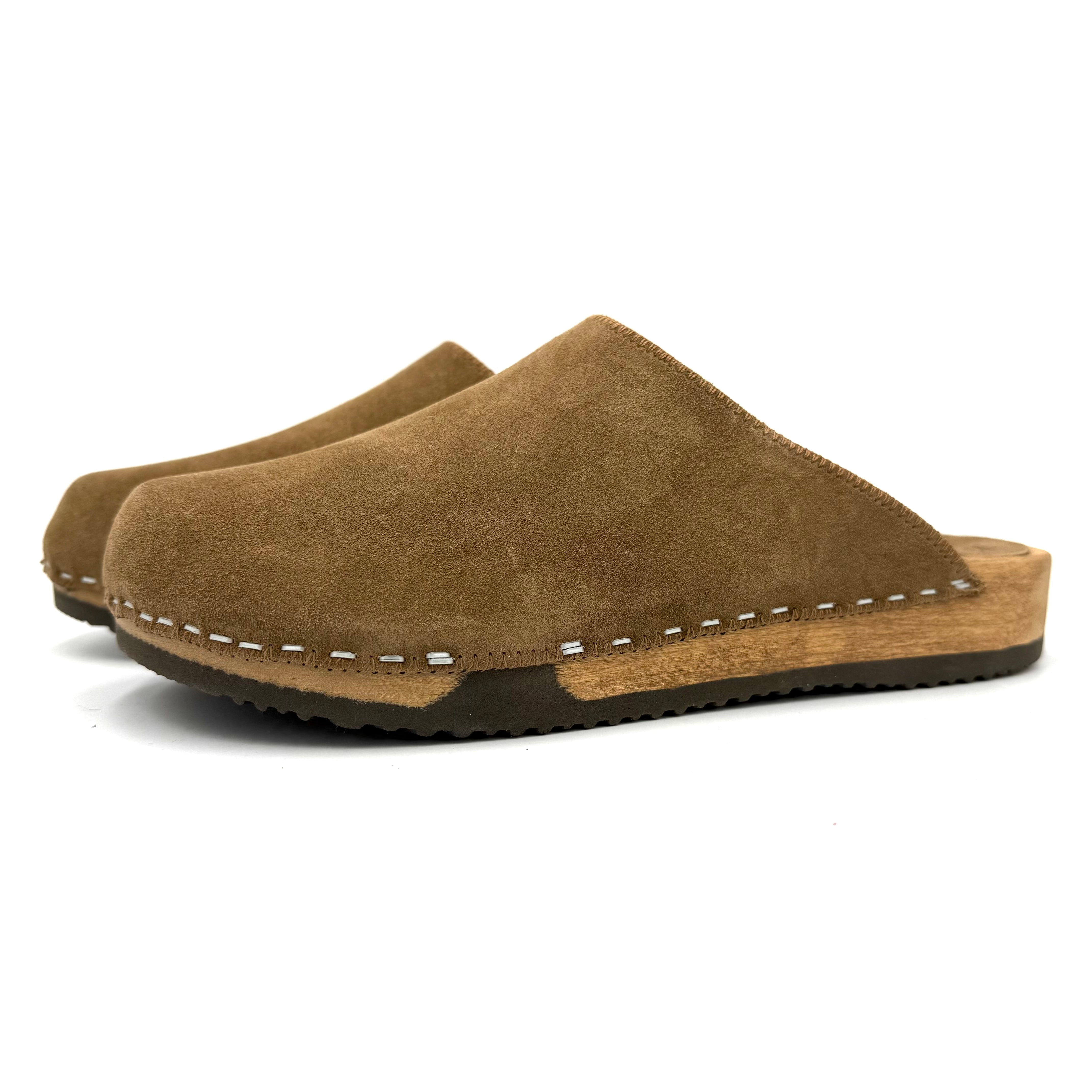 Brown suede clogs with wooden sole on a white background