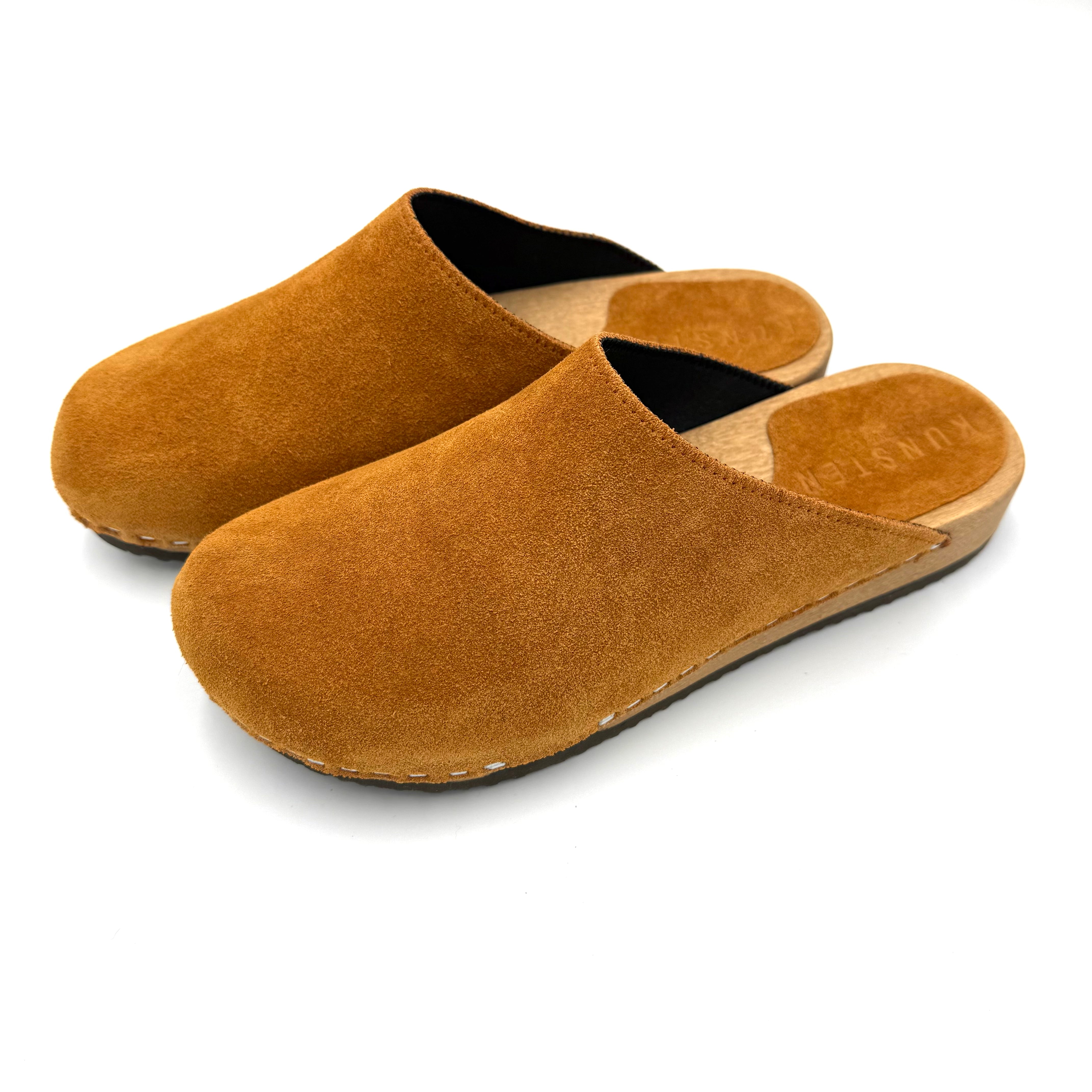 Pair of brown slippers on a white background