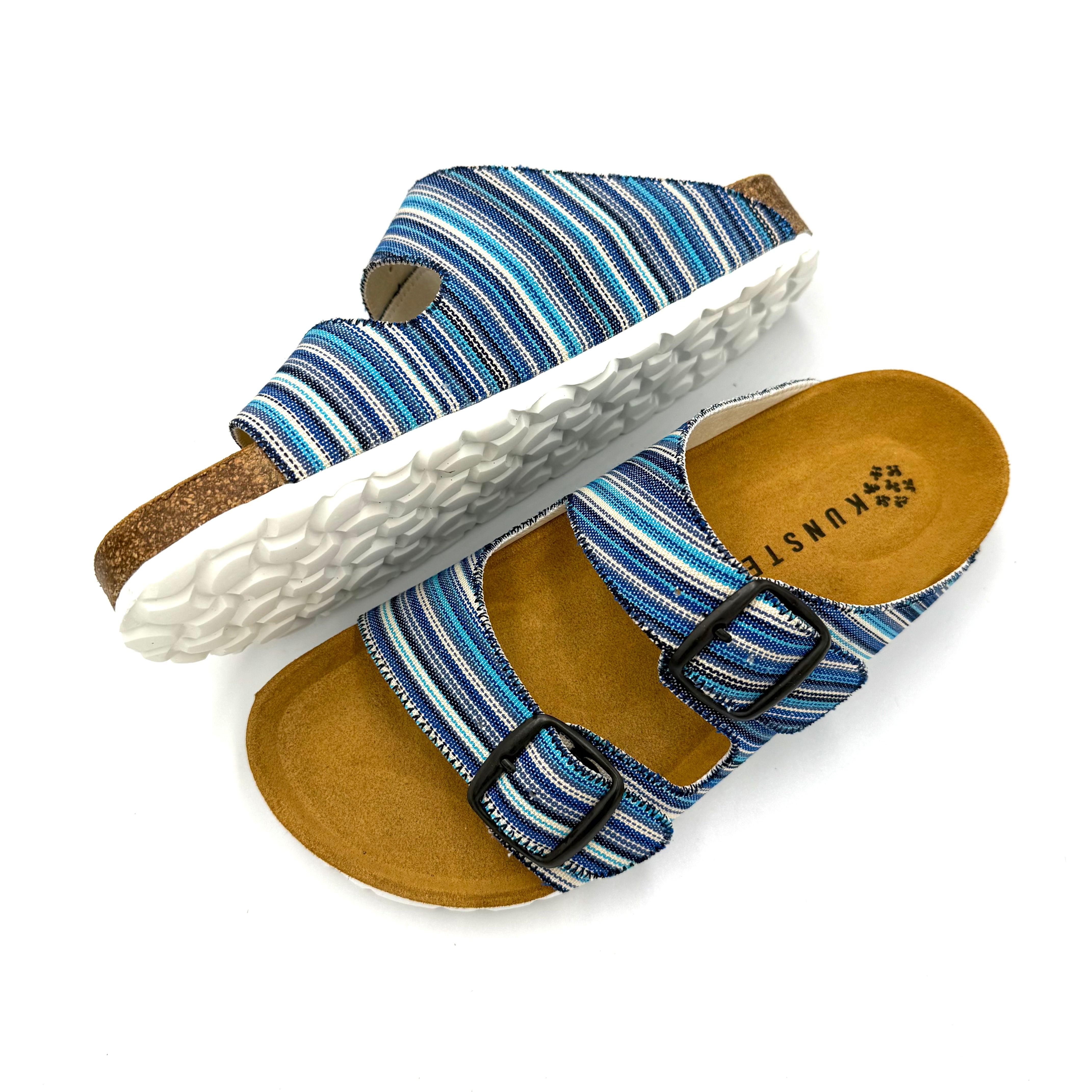 Blue striped sandals with cork sole on a white background