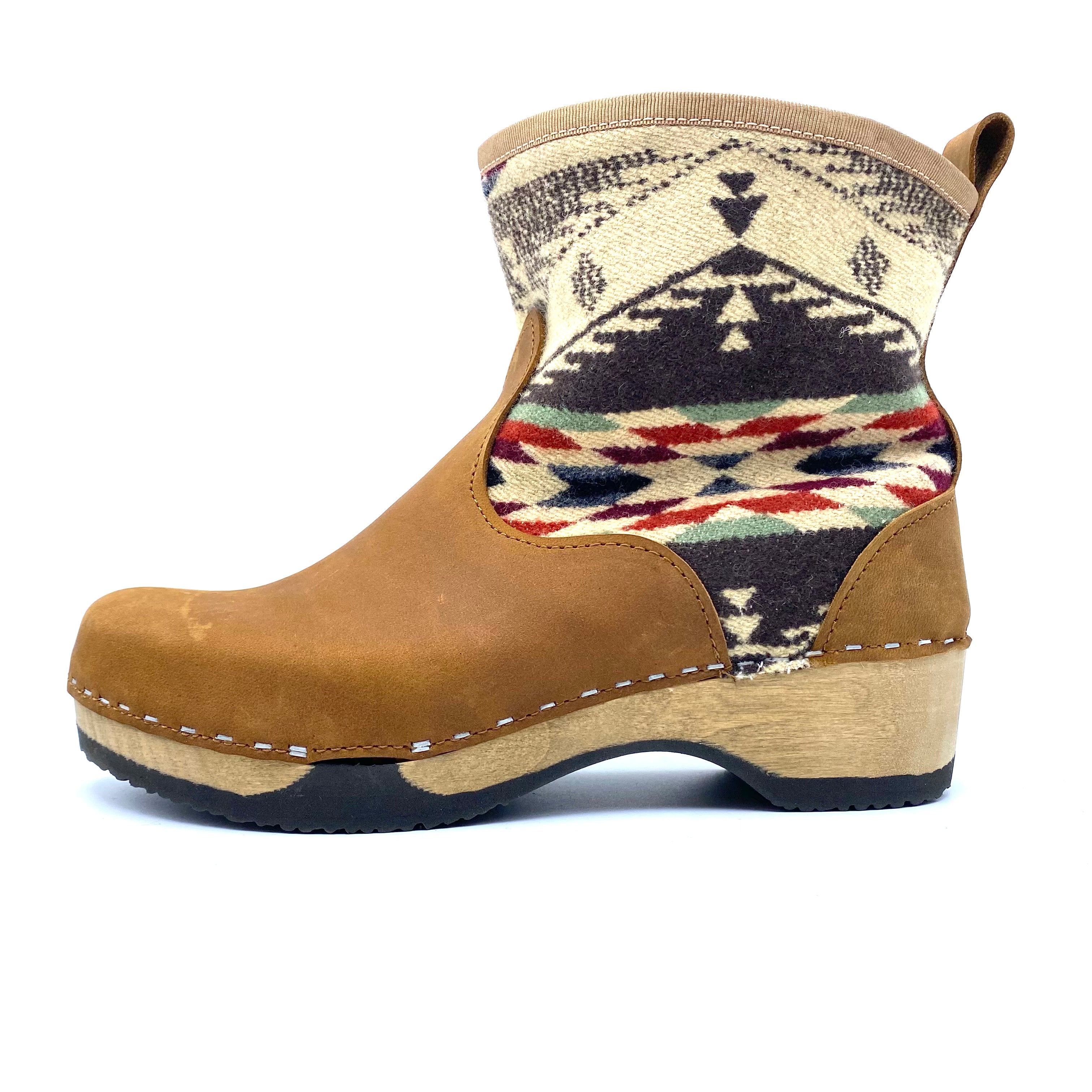 Brown boot with patterned cuff on a white background