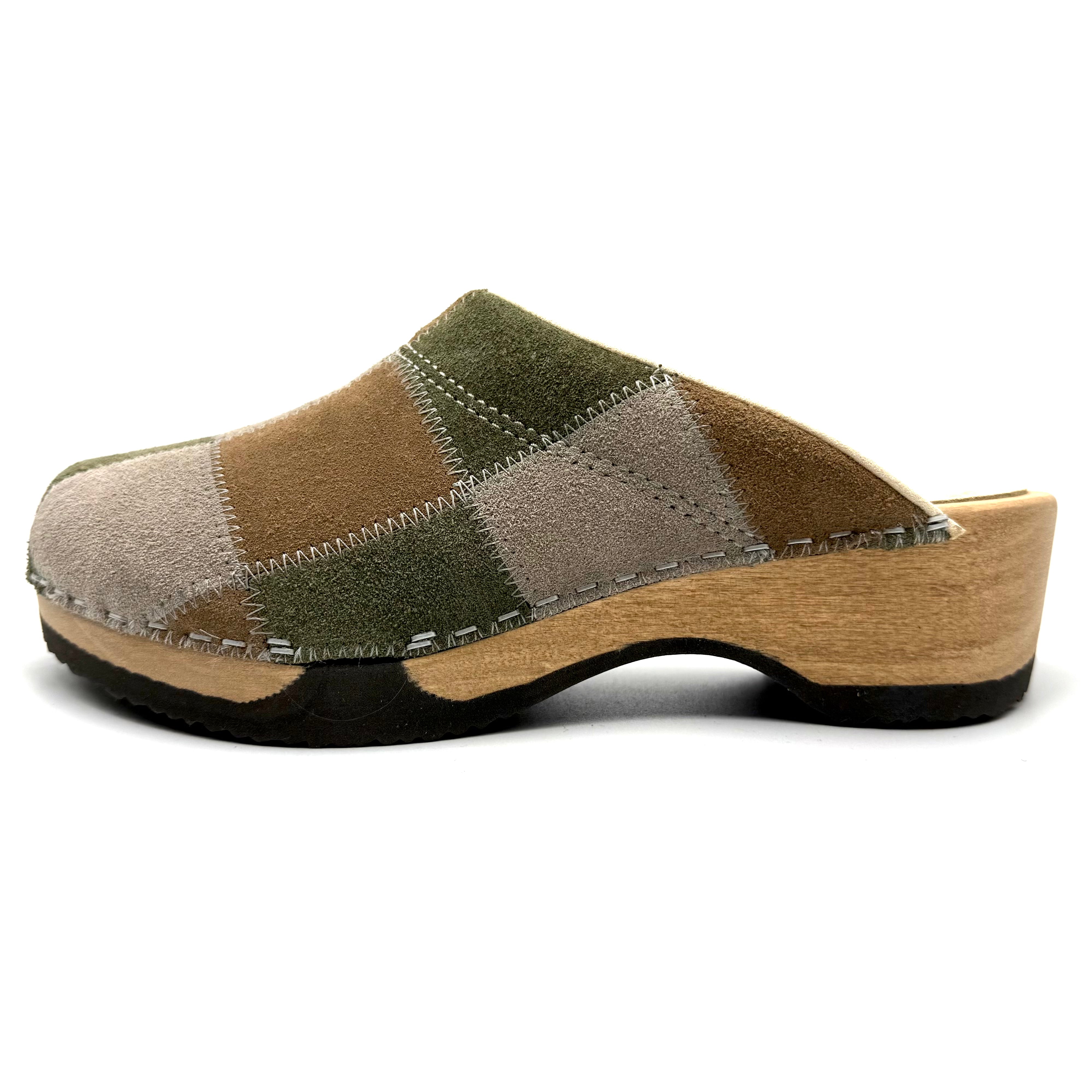 Patchwork clog shoe with wooden sole on a white background