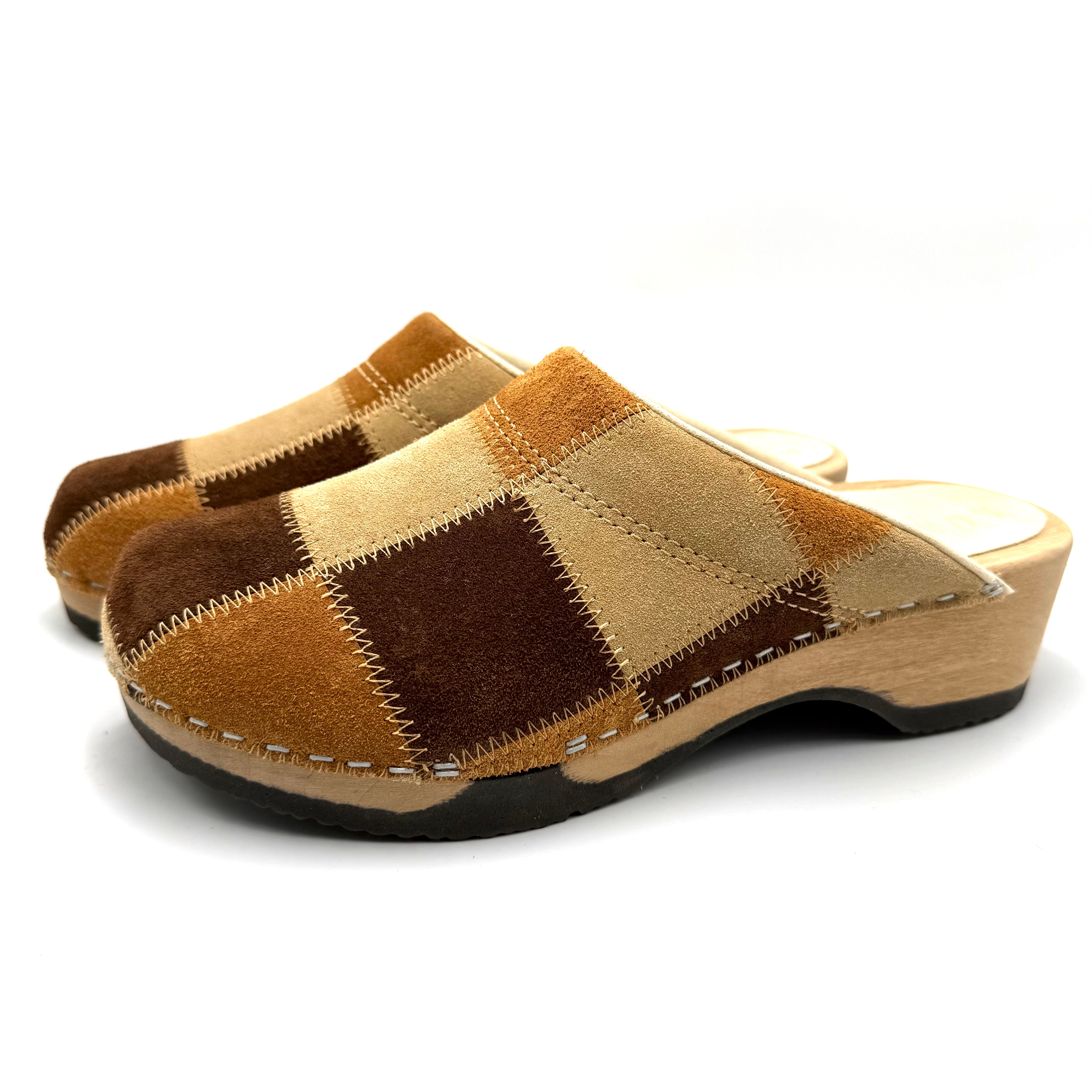 Pair of brown and beige checkered clogs on a white background