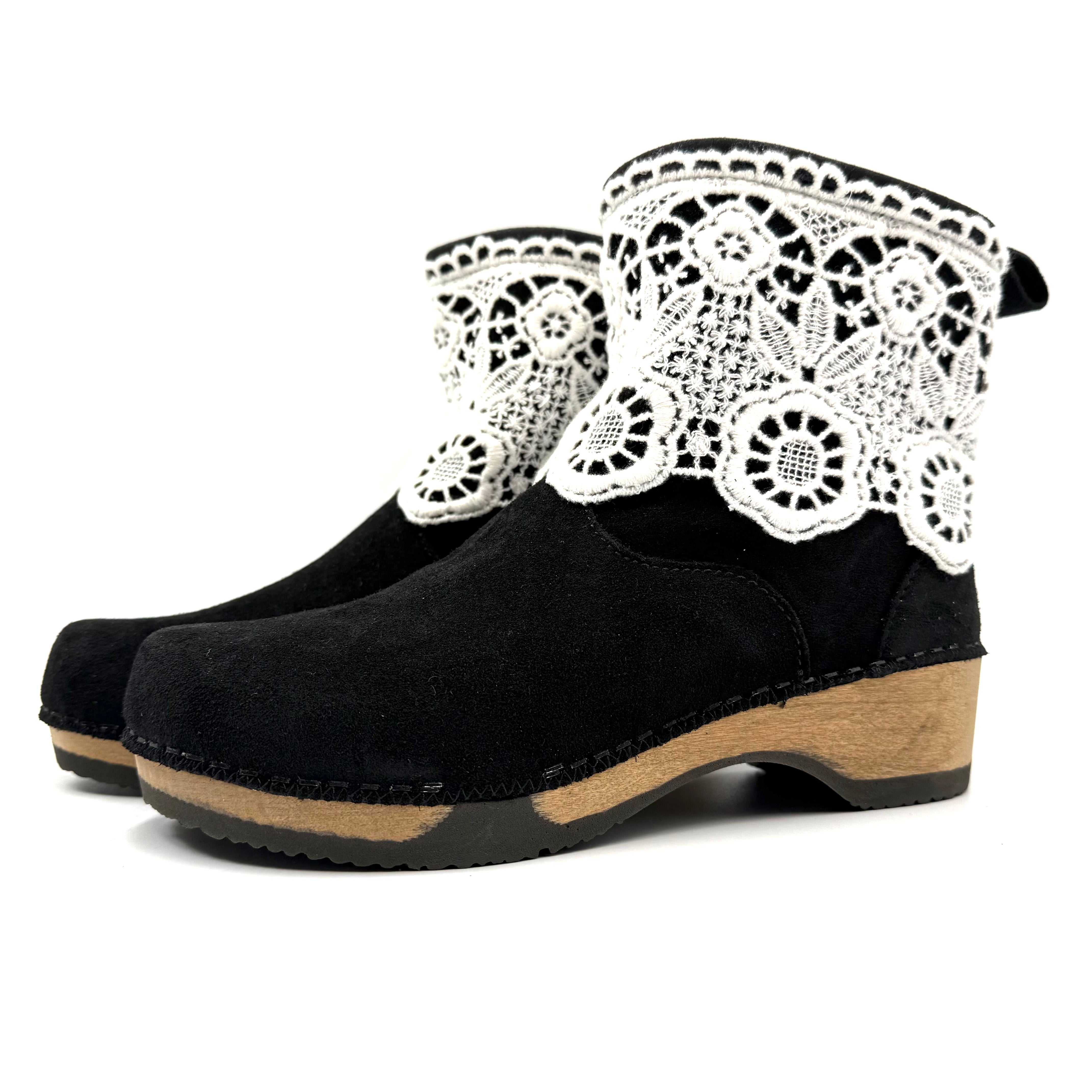 Black clog shoes with white lace on a white background
