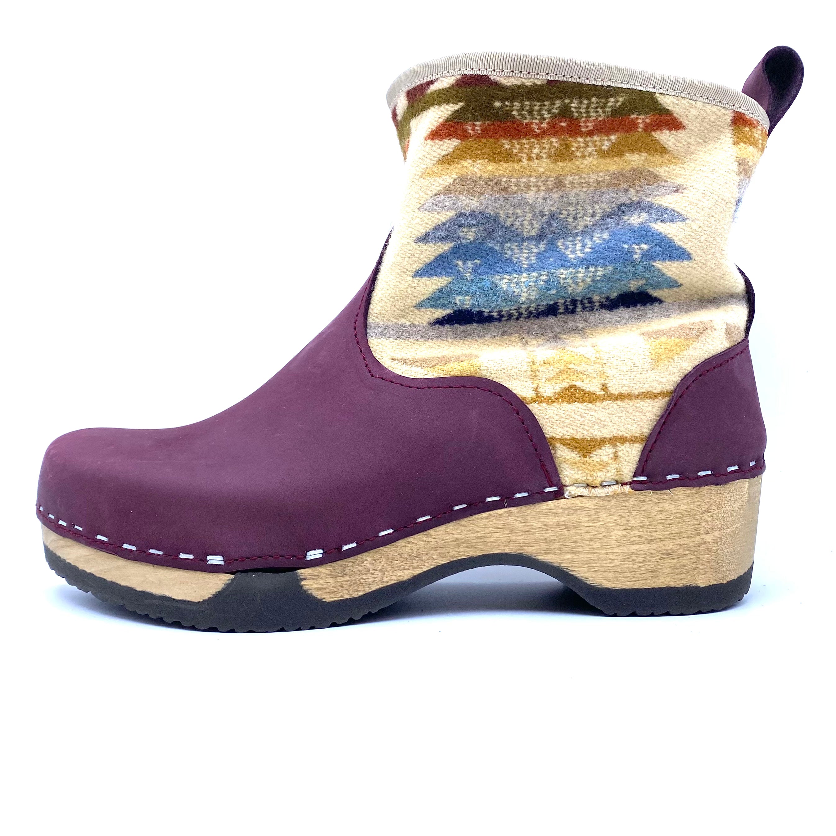 Purple clog shoe with patterned insole on a white background