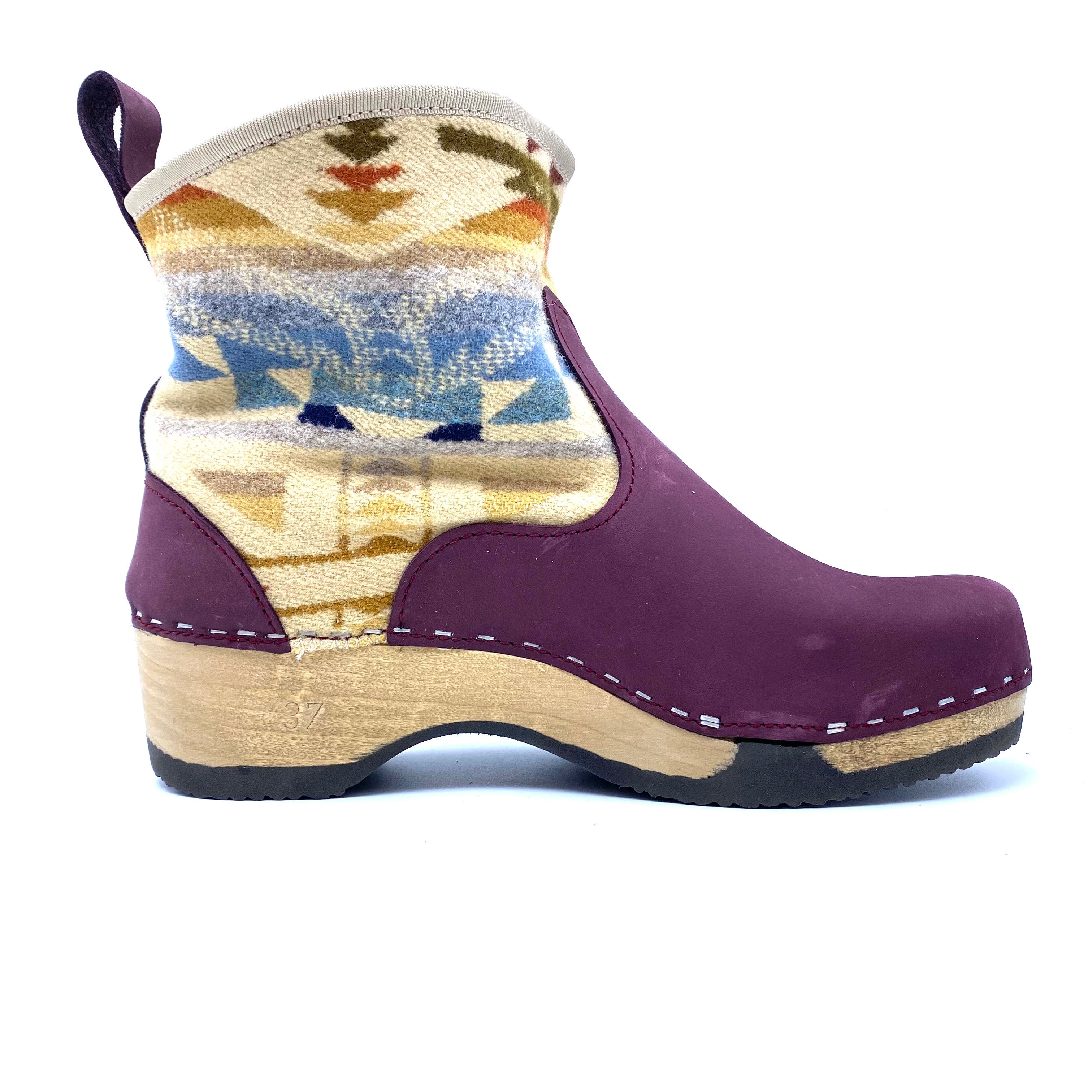 Purple clog shoe with patterned upper on a white background