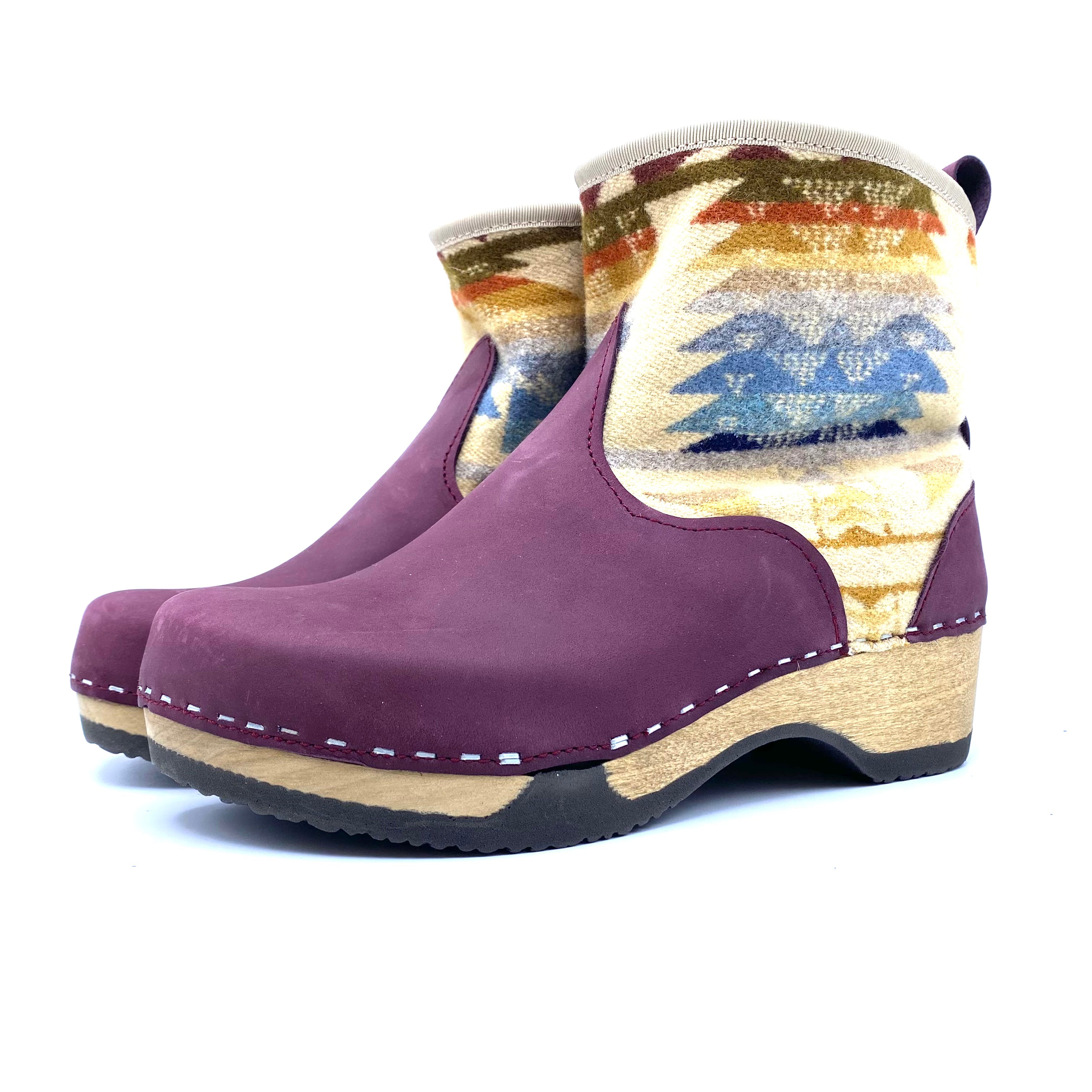 Purple clog boots with a patterned sock on a white background