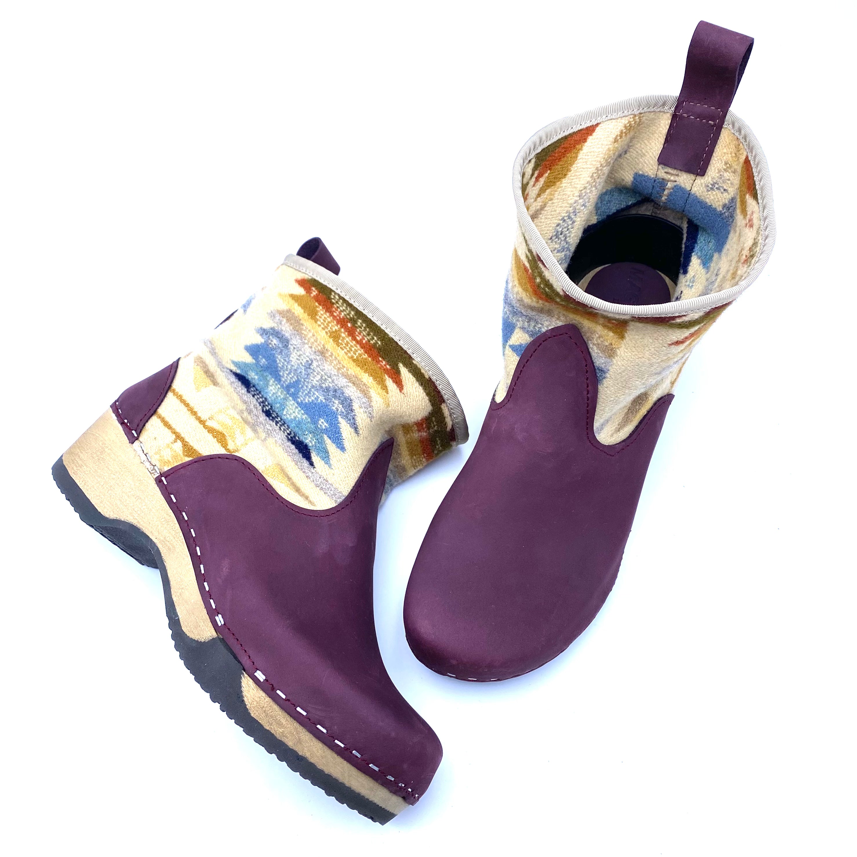 Pair of purple rubber boots with patterned lining on a white background