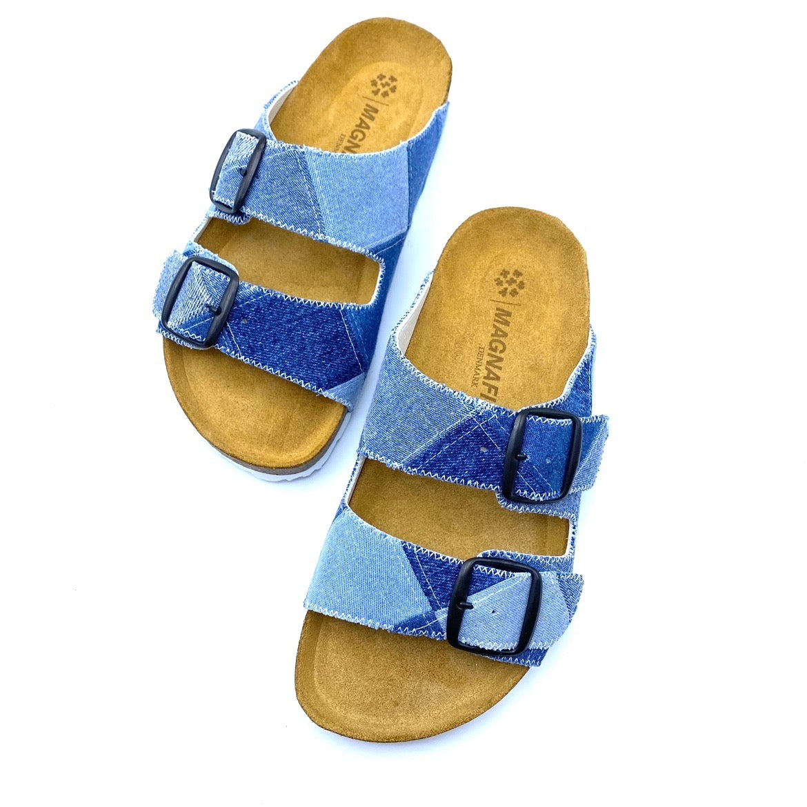 Blue patterned sandals with brown soles on a white background