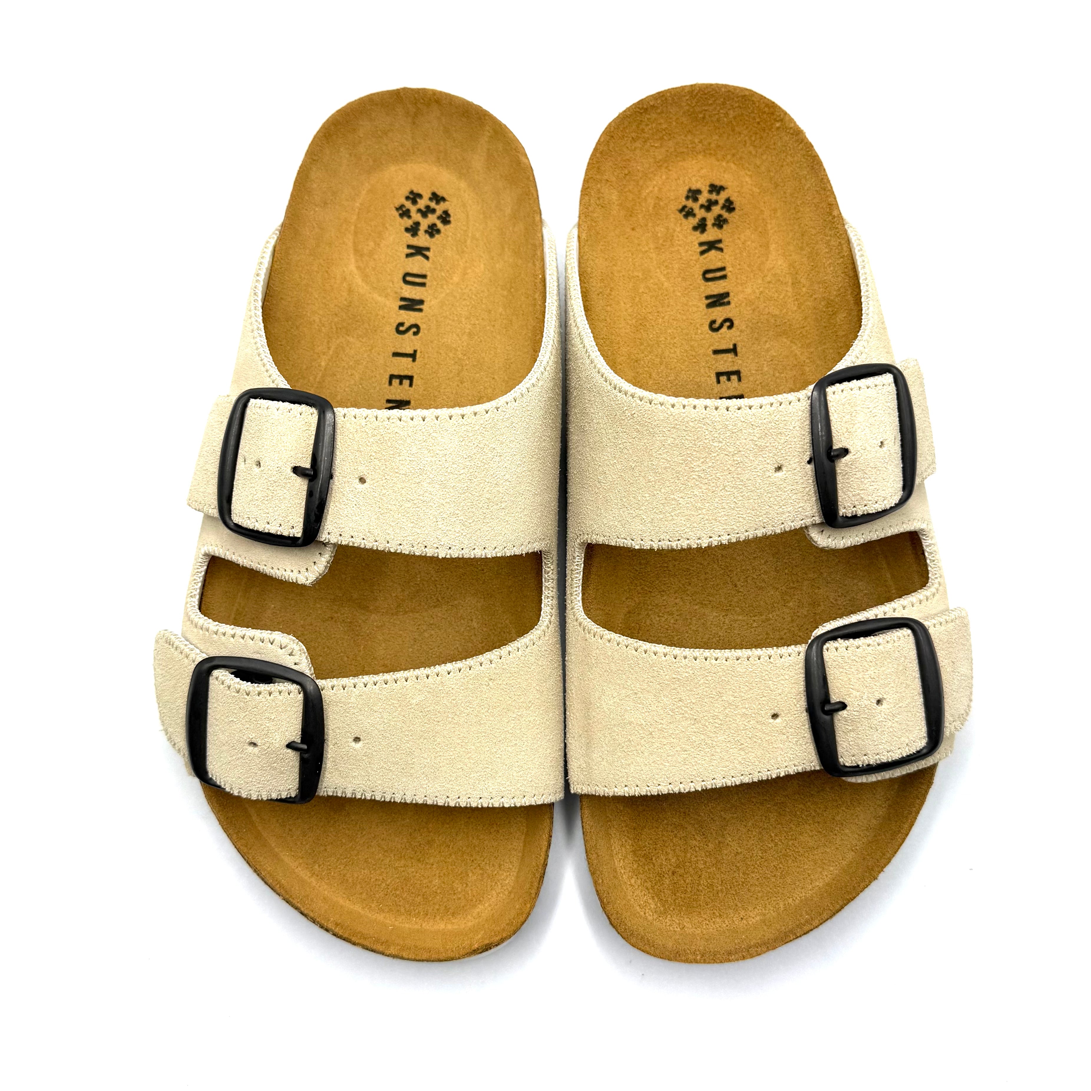 Brown sandal with a buckle on a white background
