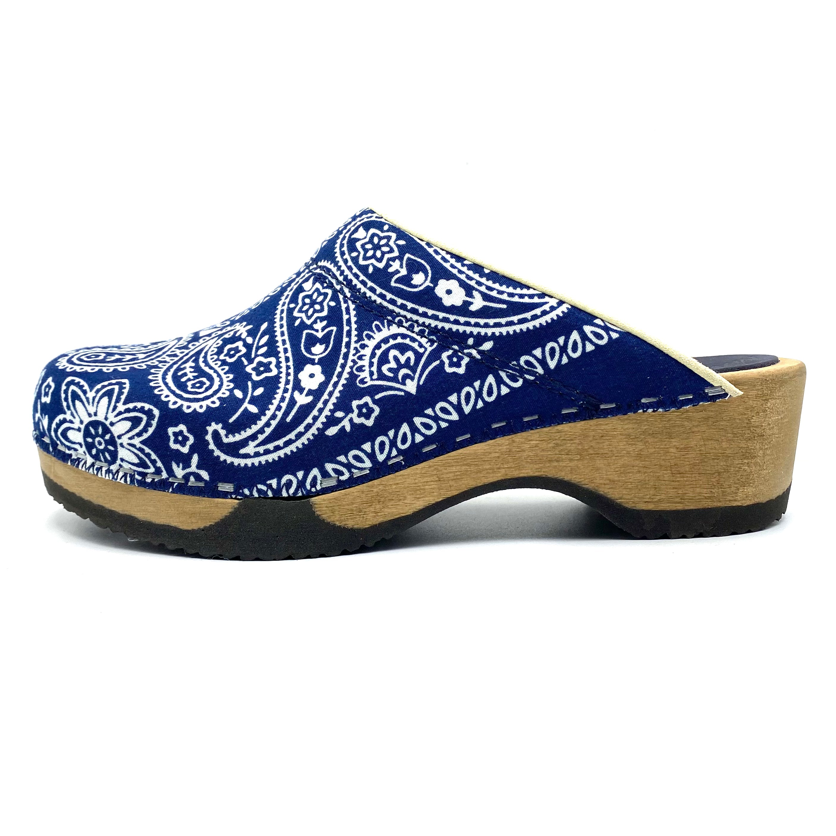 Blue bandana patterned clog shoe with a wooden sole on a white background