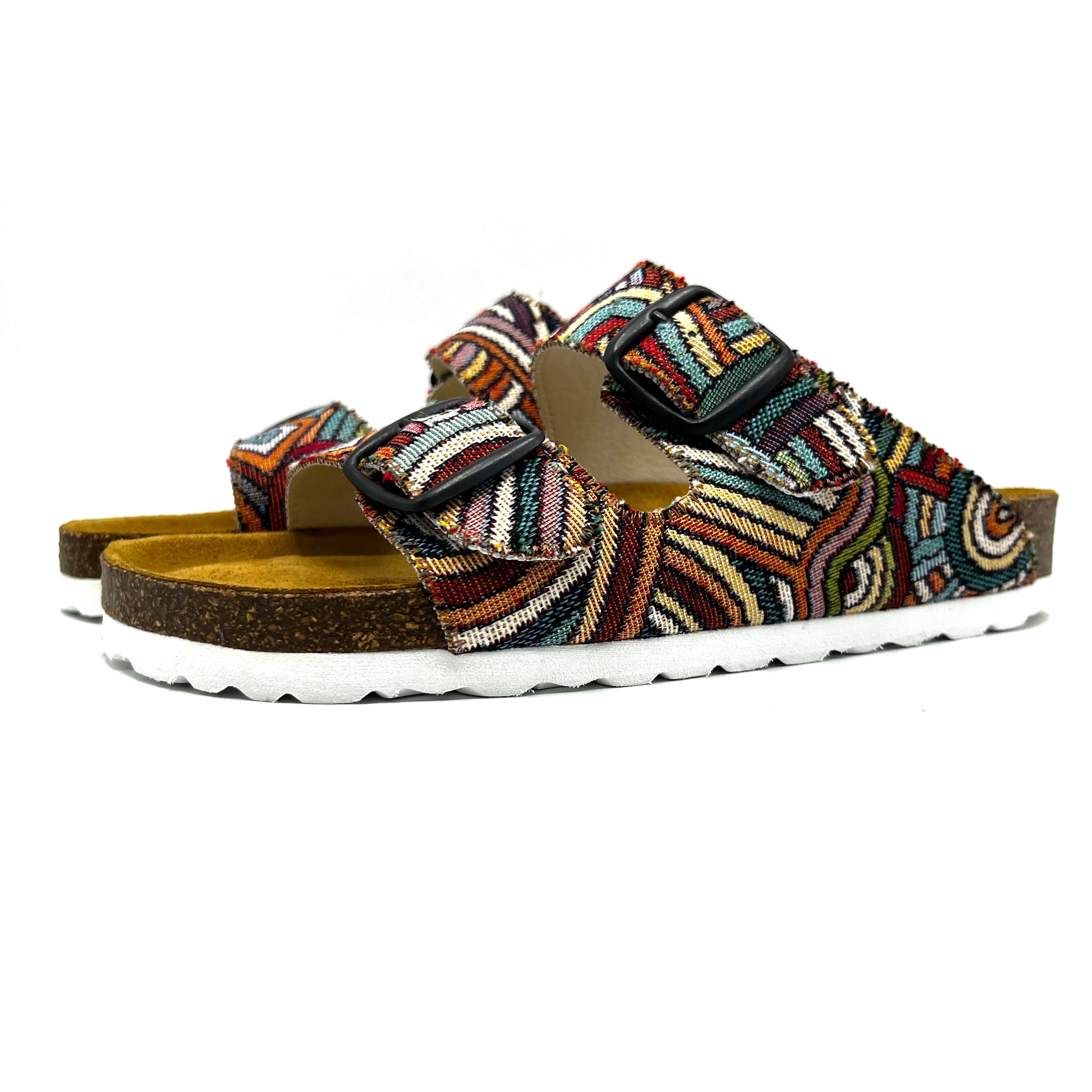 Multicolored sandals with a patterned strap on a white background