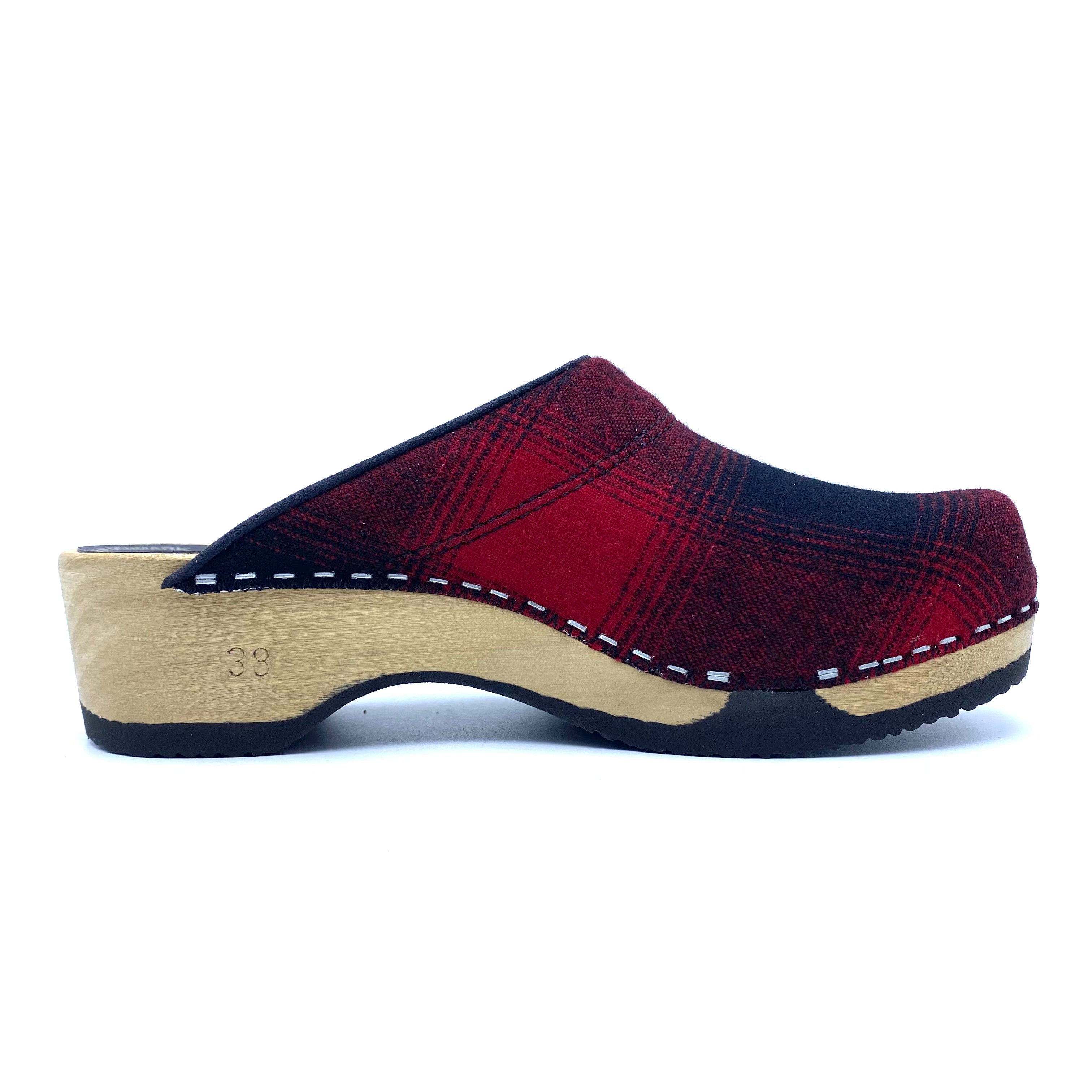 Red and black clog shoe with wooden sole on a white background