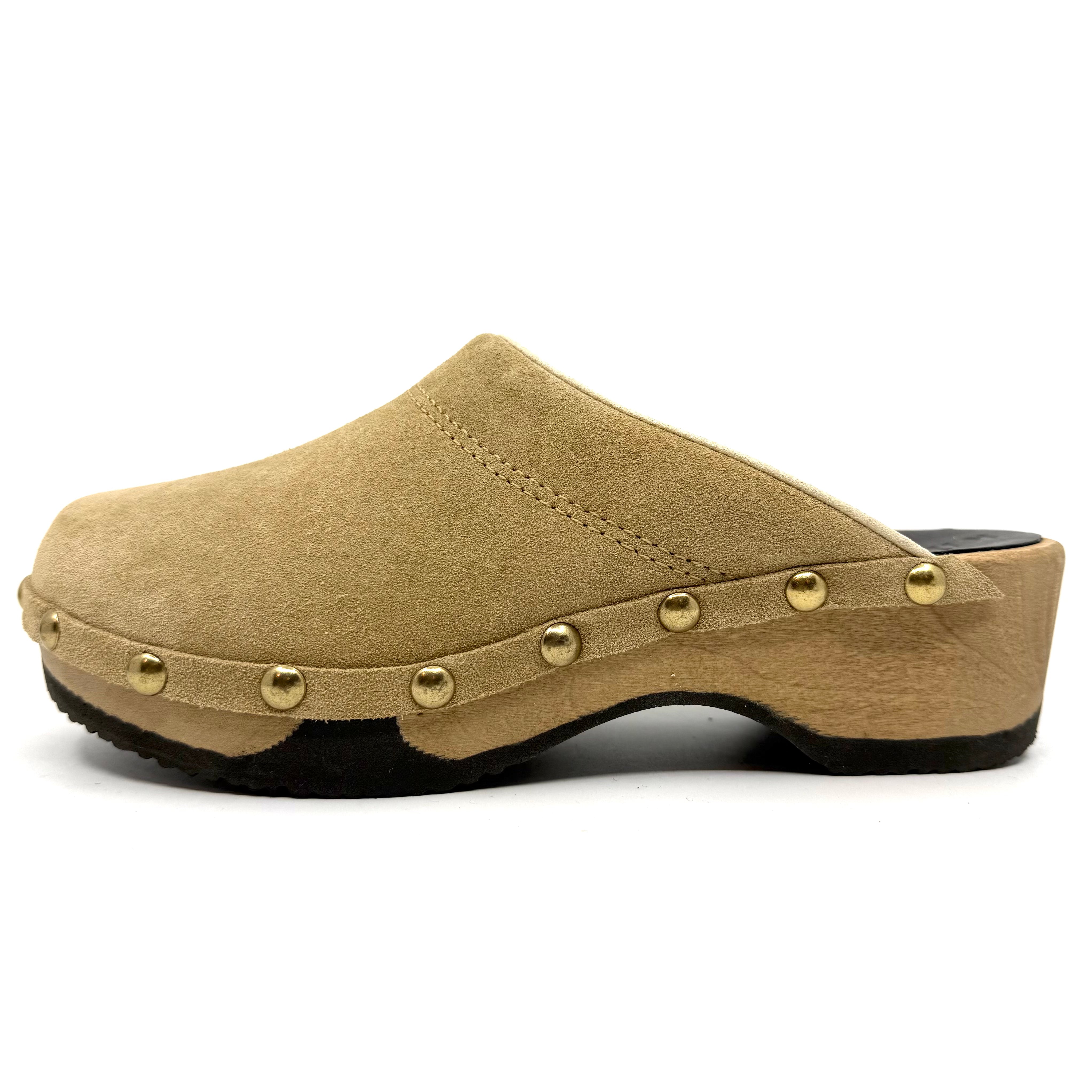 Beige clog shoe with gold studs on a white background