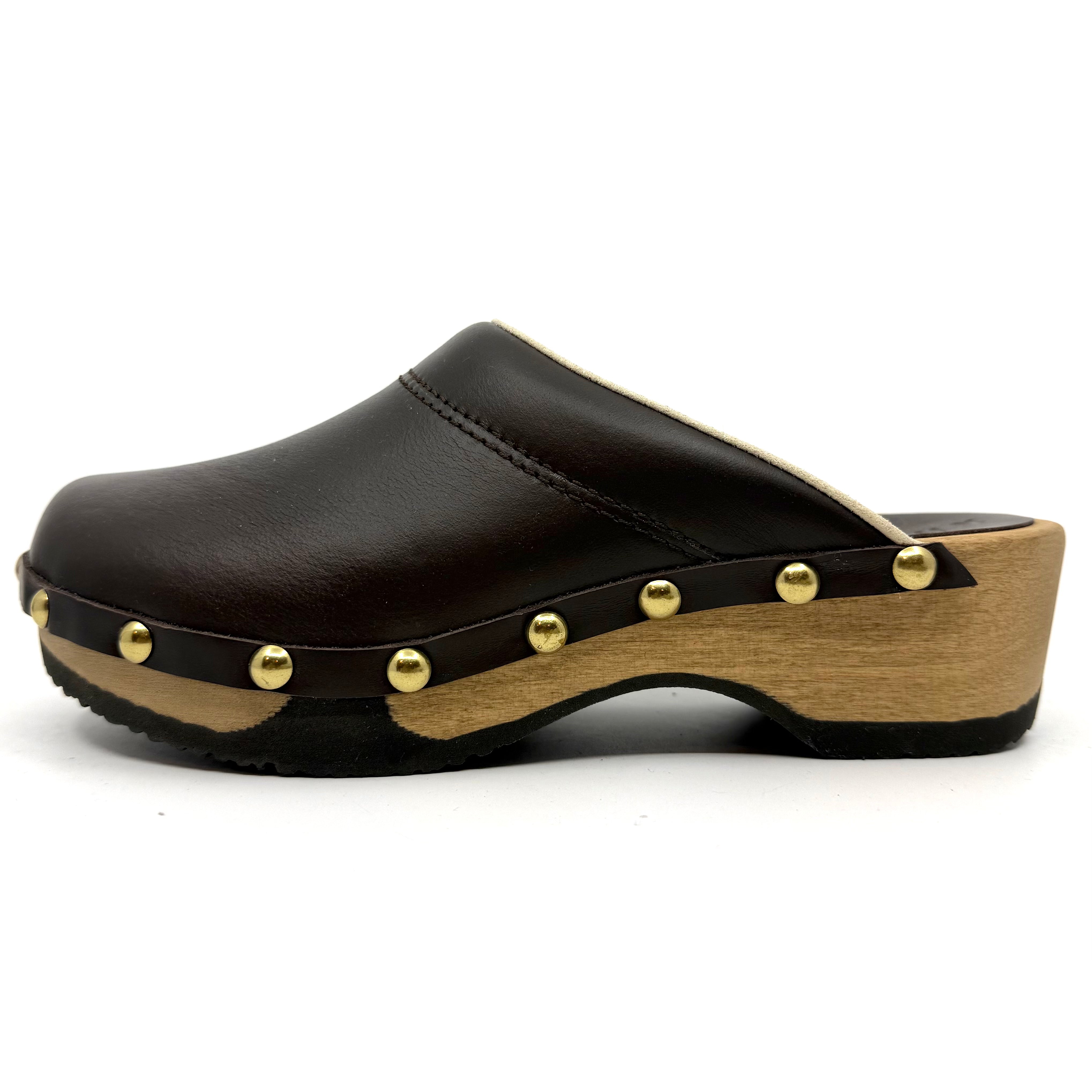 Black leather clog with wooden sole and gold studs on a white background