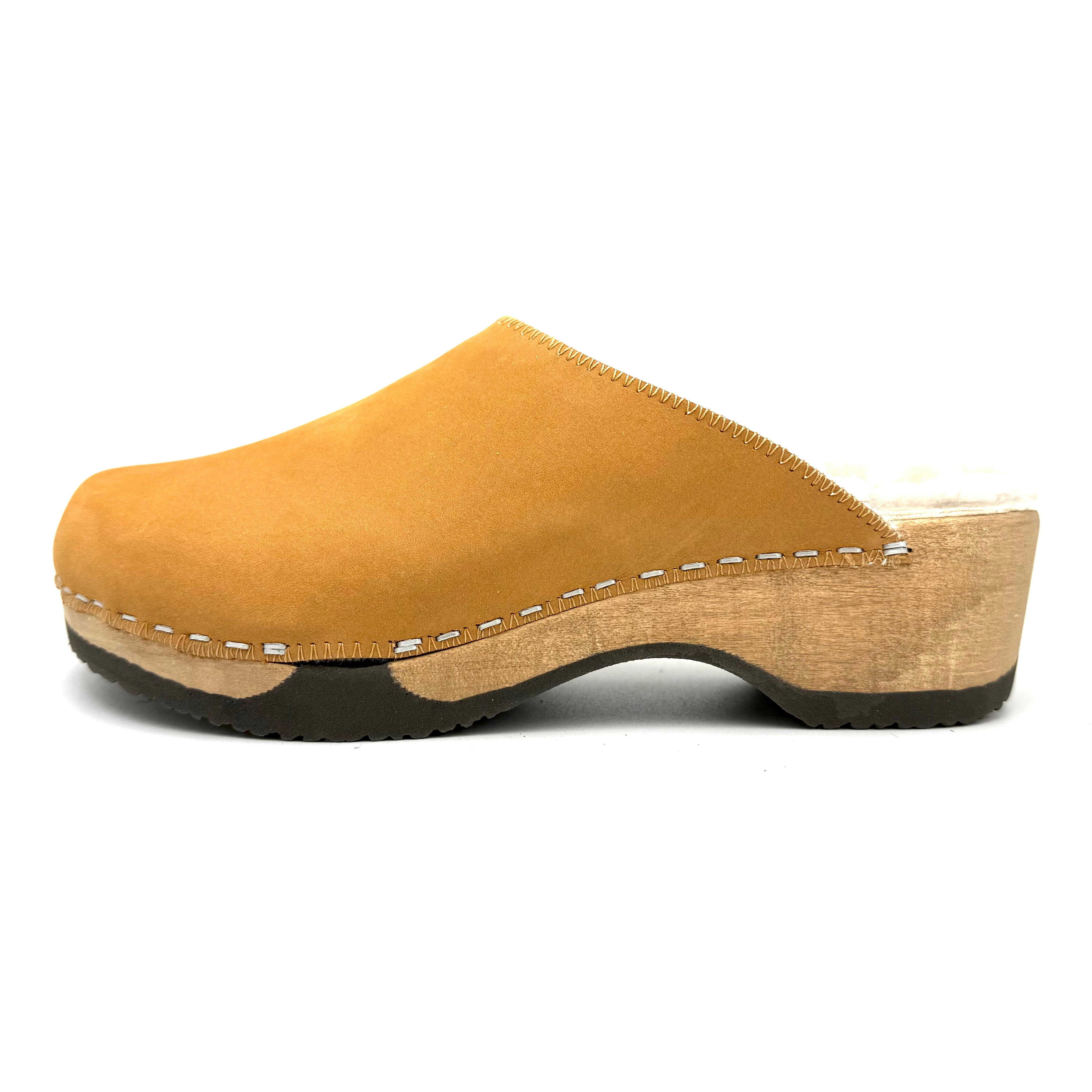 Mustard yellow wooden clog shoe on a white background