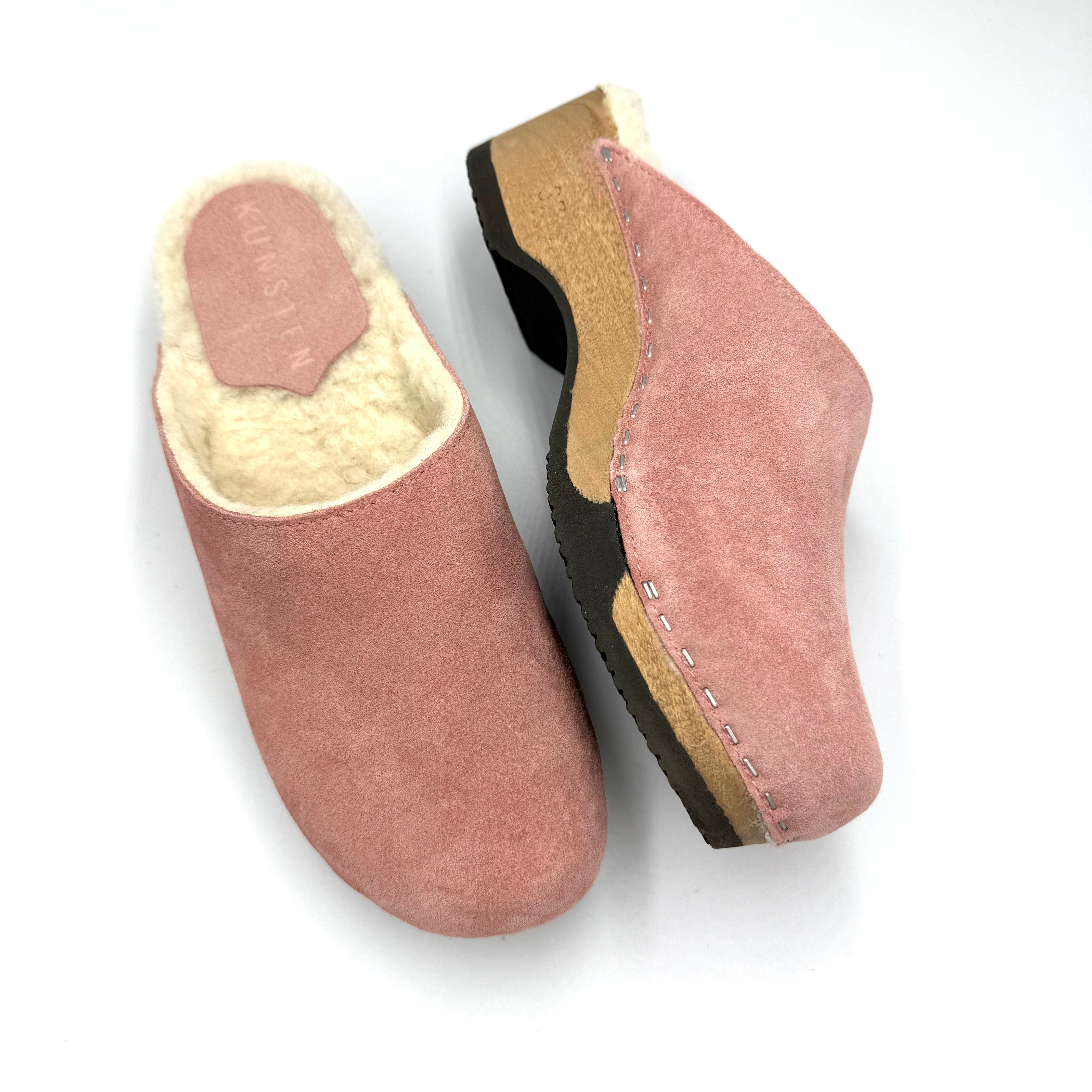Pair of pink slippers with a white background