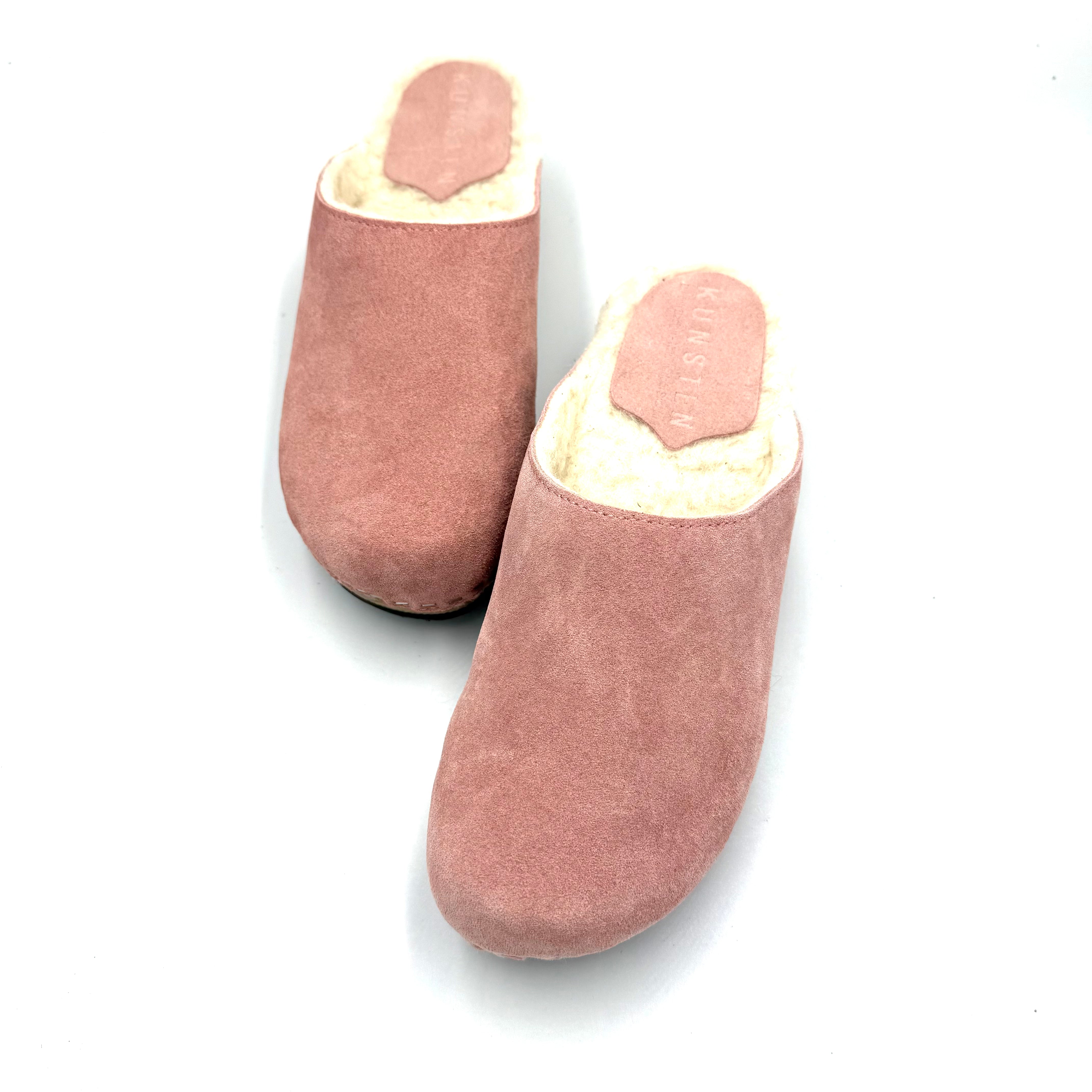 Pair of pink slippers on a white background