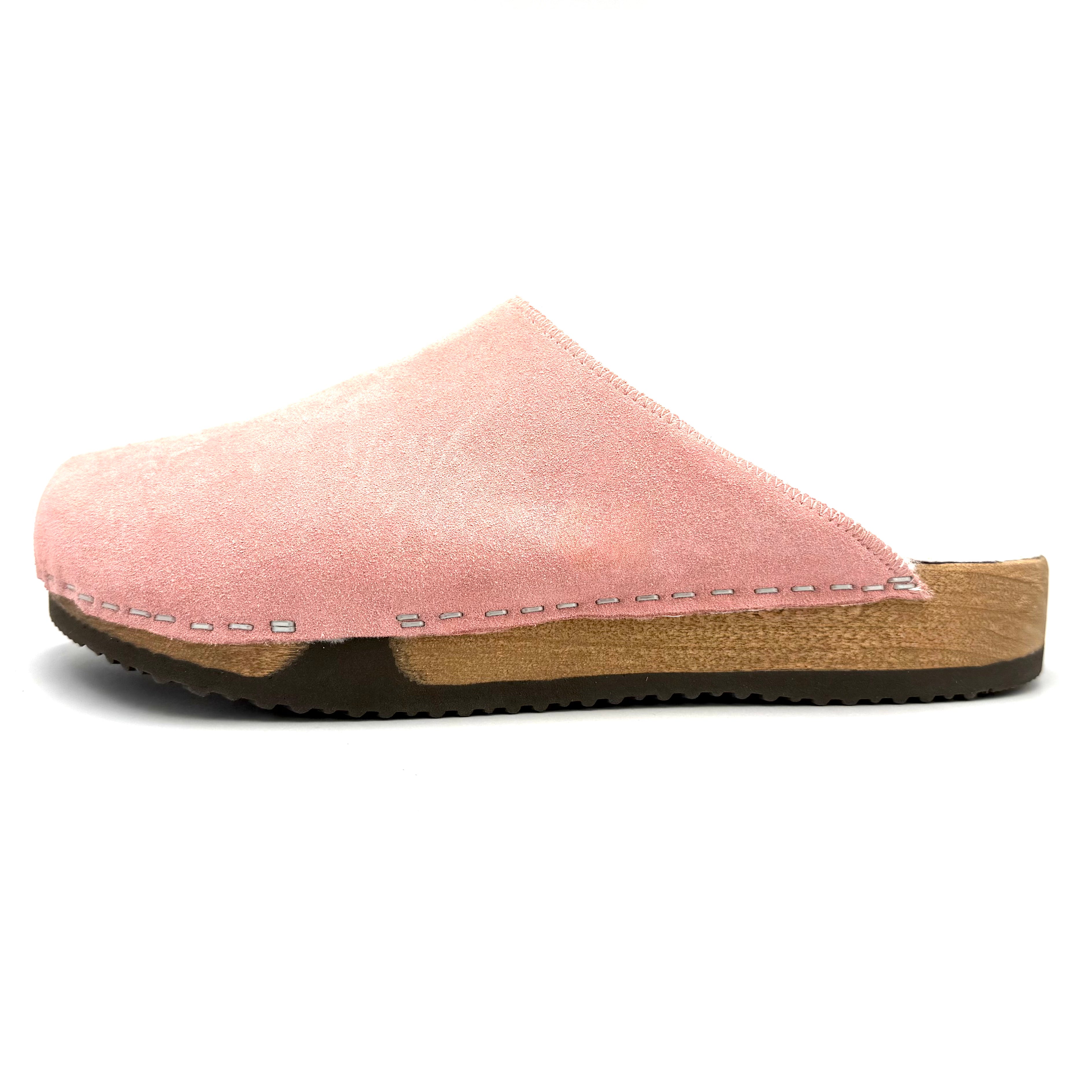 Pink clog shoe with a wooden sole on a white background