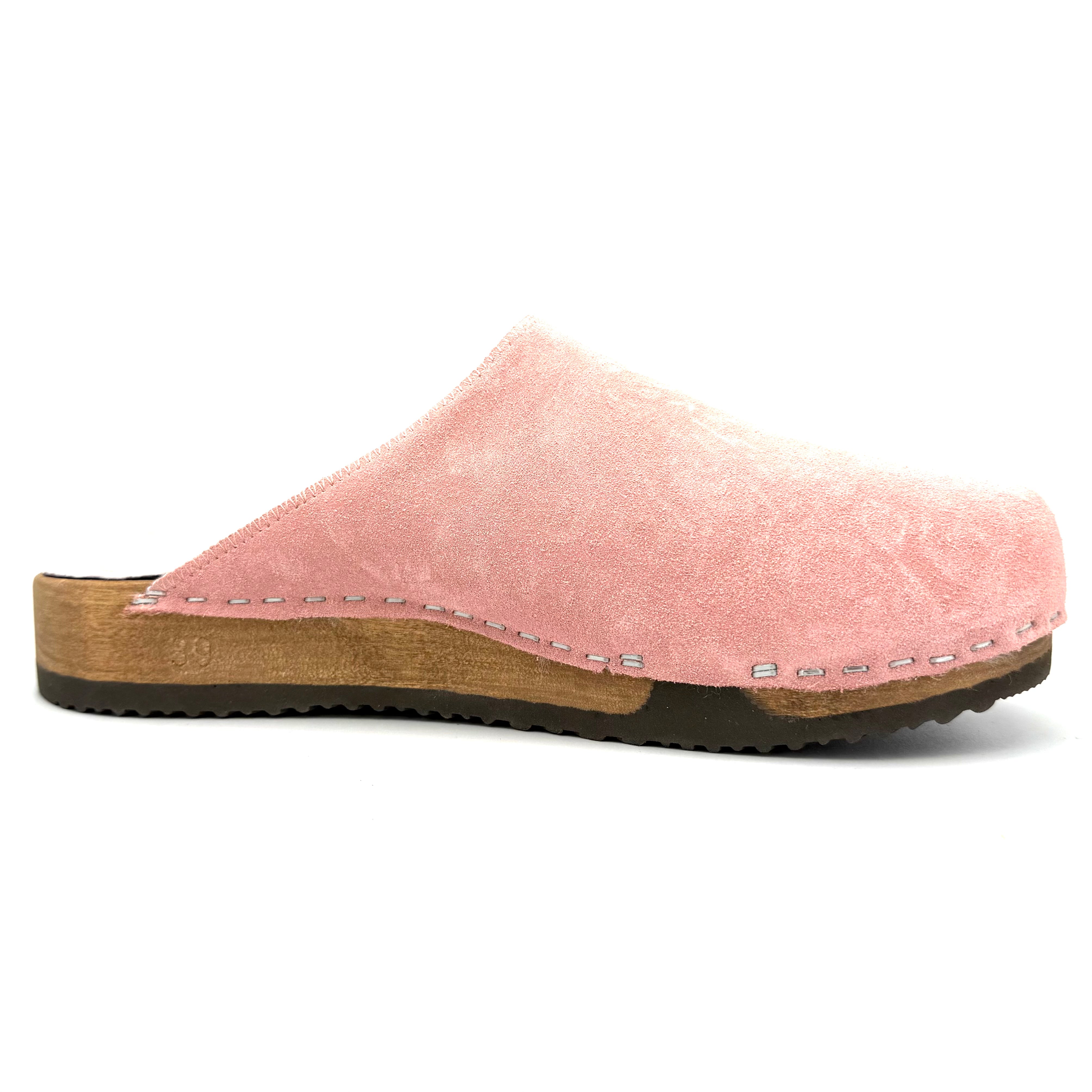 Pink clog shoe with wooden sole on a white background