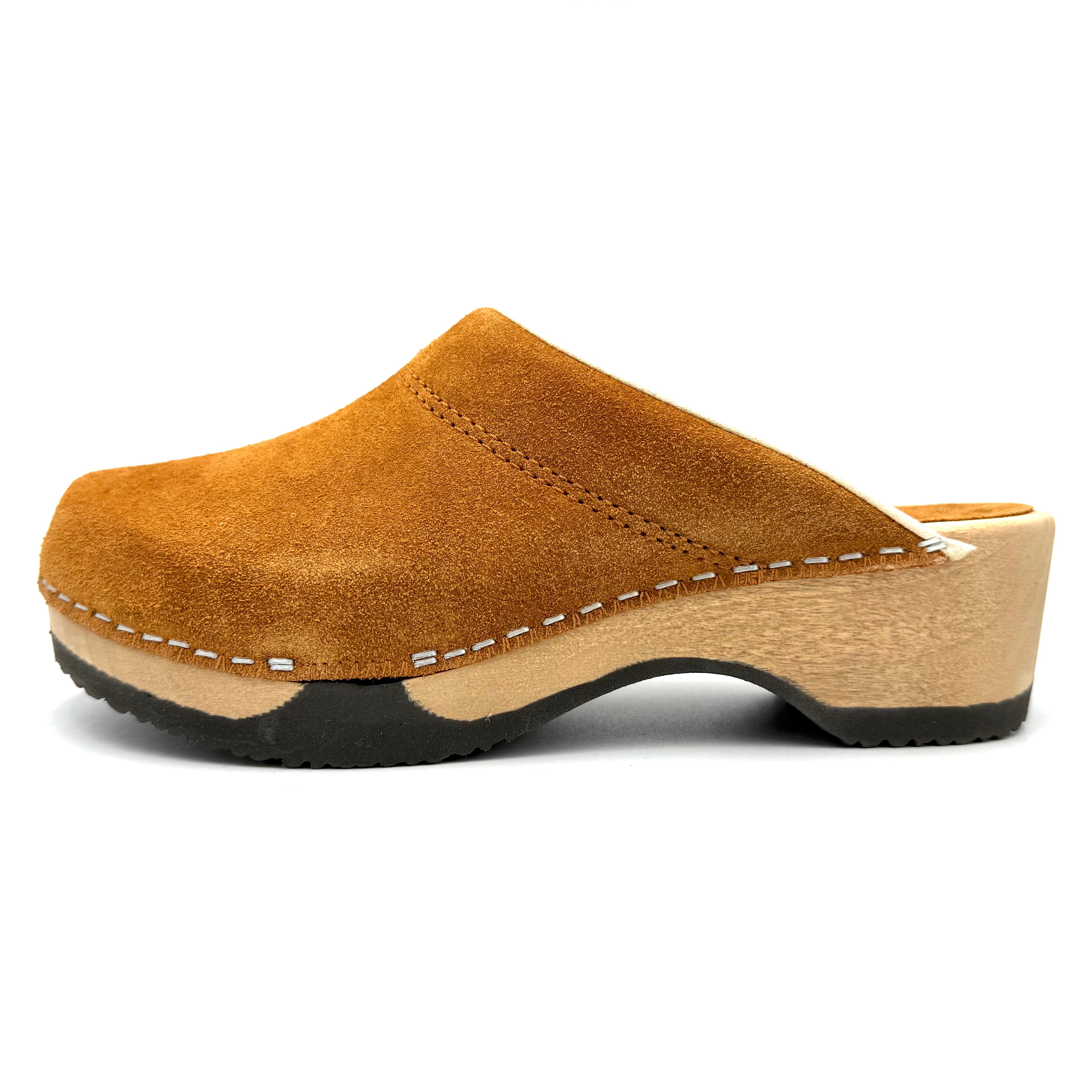 Brown suede clog shoe on a white background