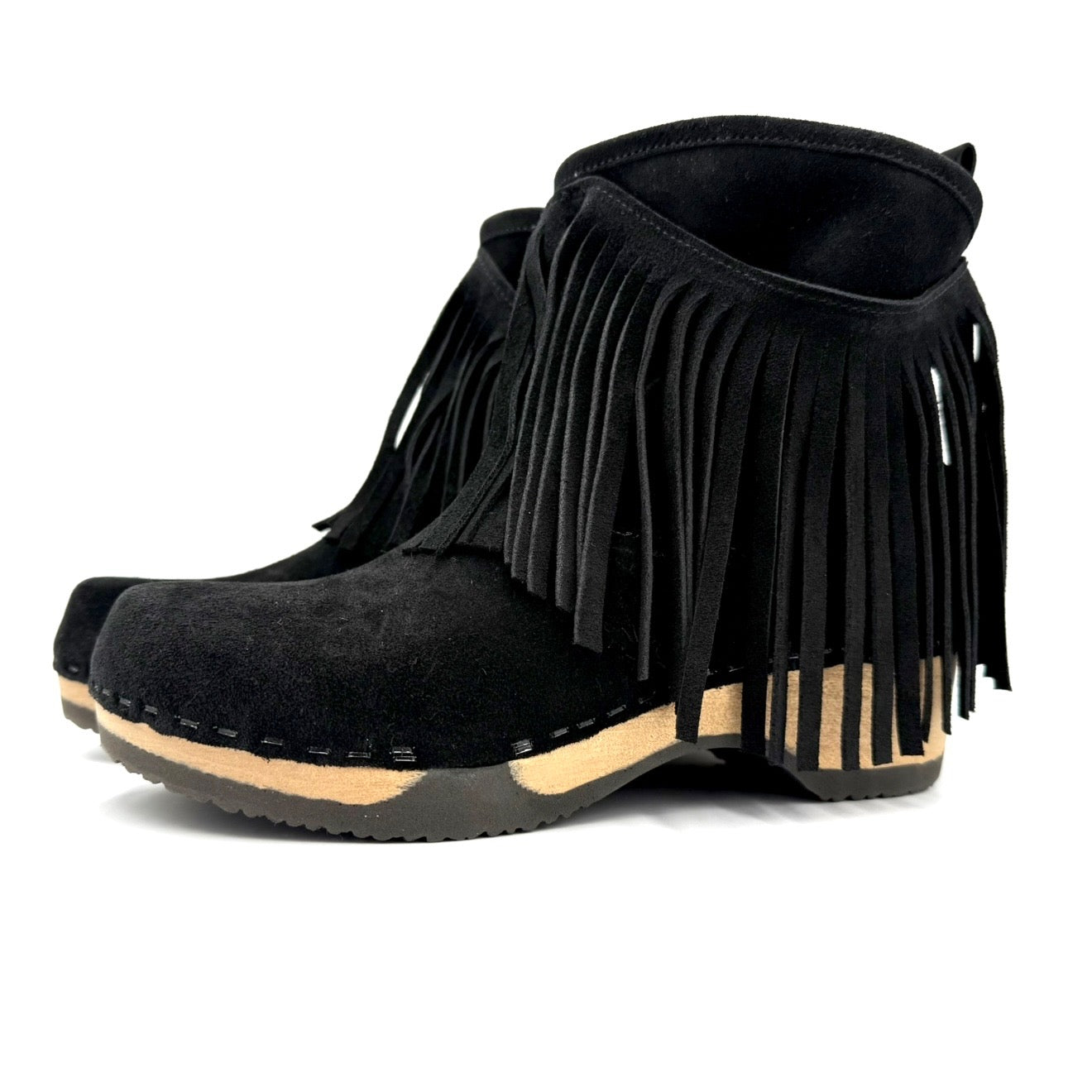 Black suede ankle boots with fringe on a white background