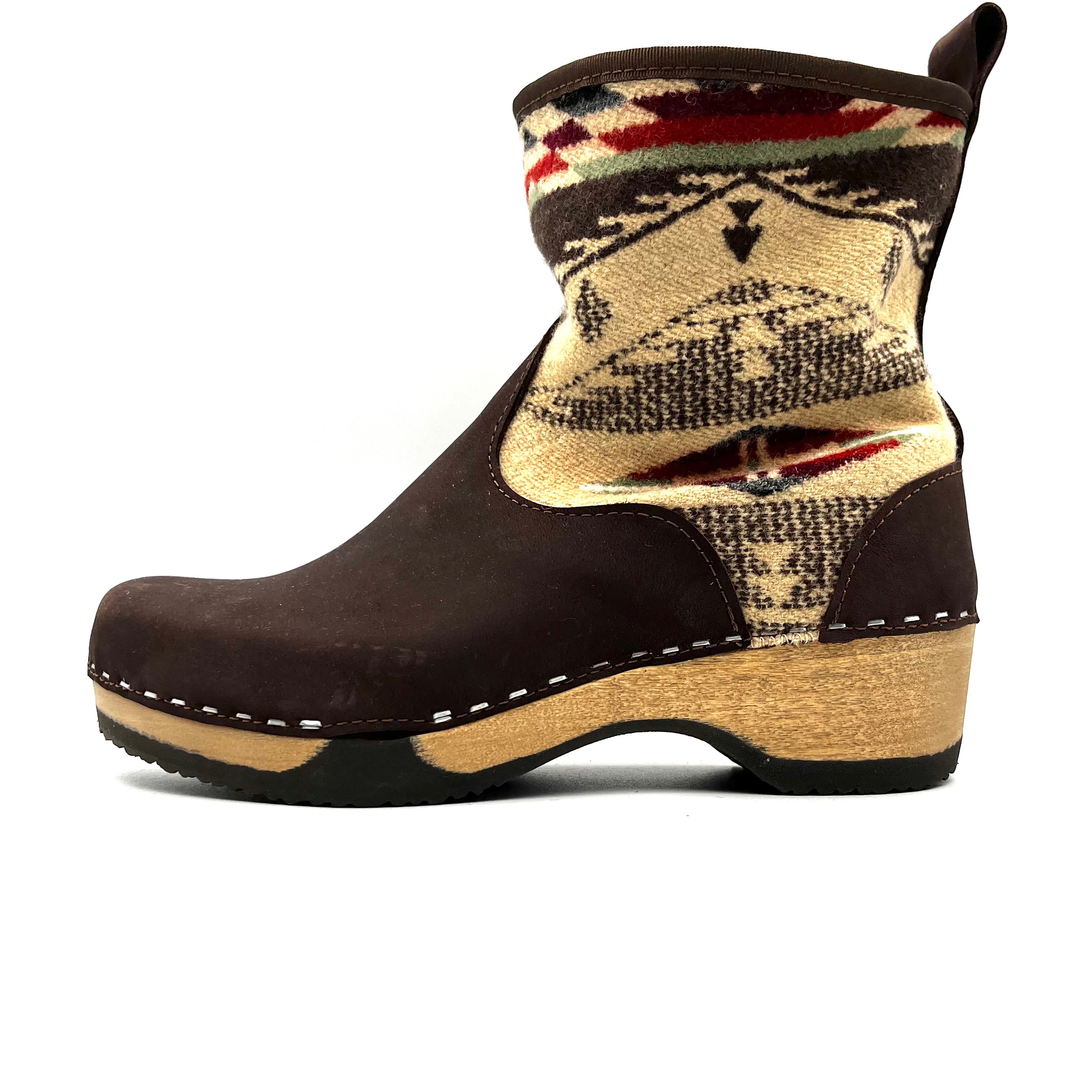 Brown boot with patterned top on a white background