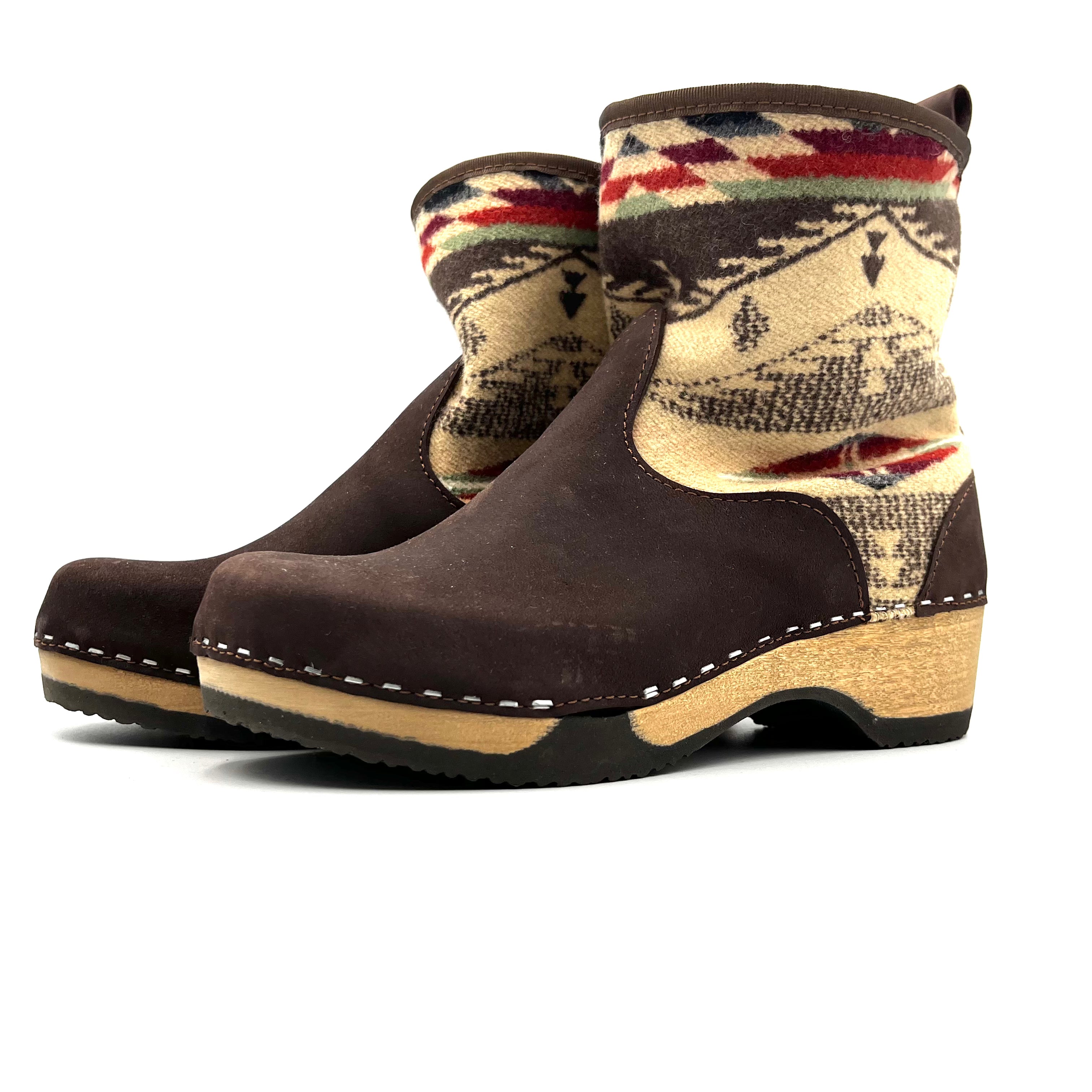 Brown boot with patterned top on a white background