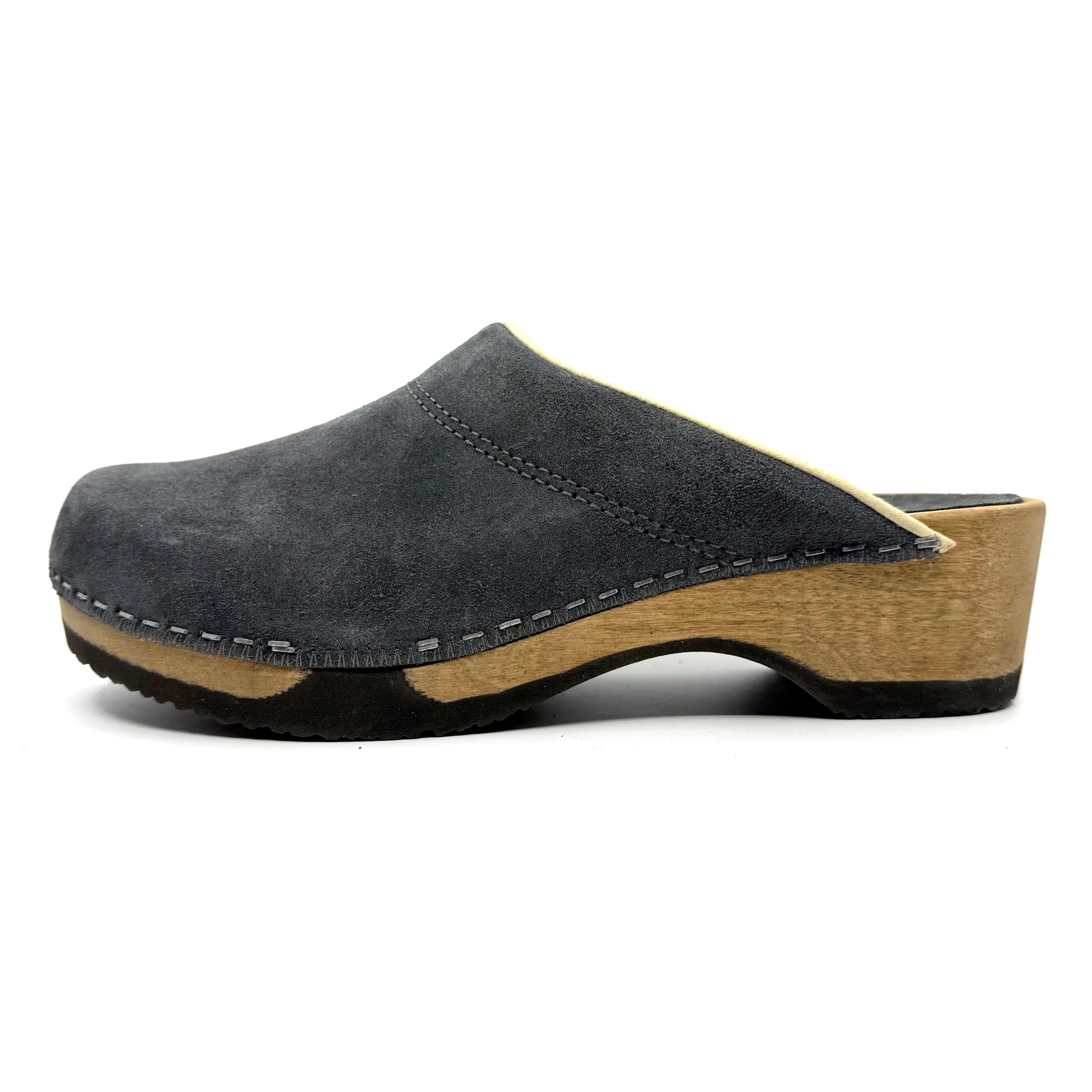 Gray suede clog shoe with wooden sole on a white background