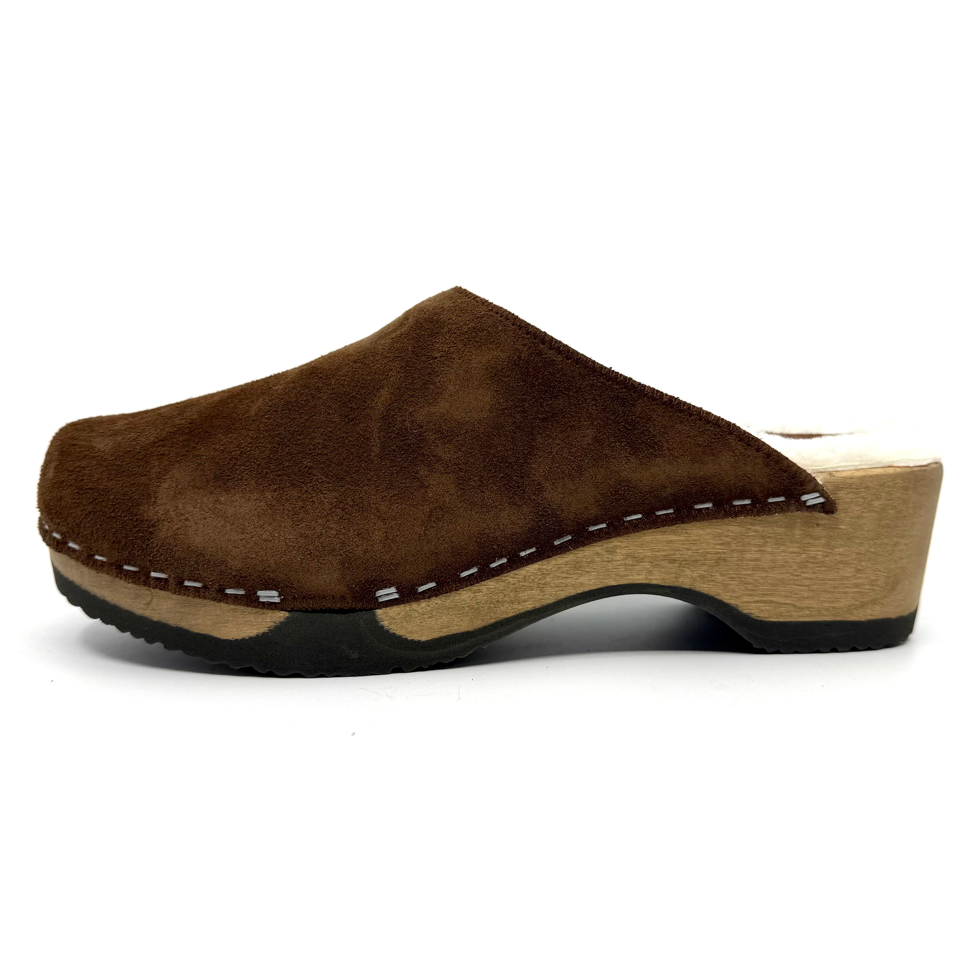 Brown suede clog shoe on a white background
