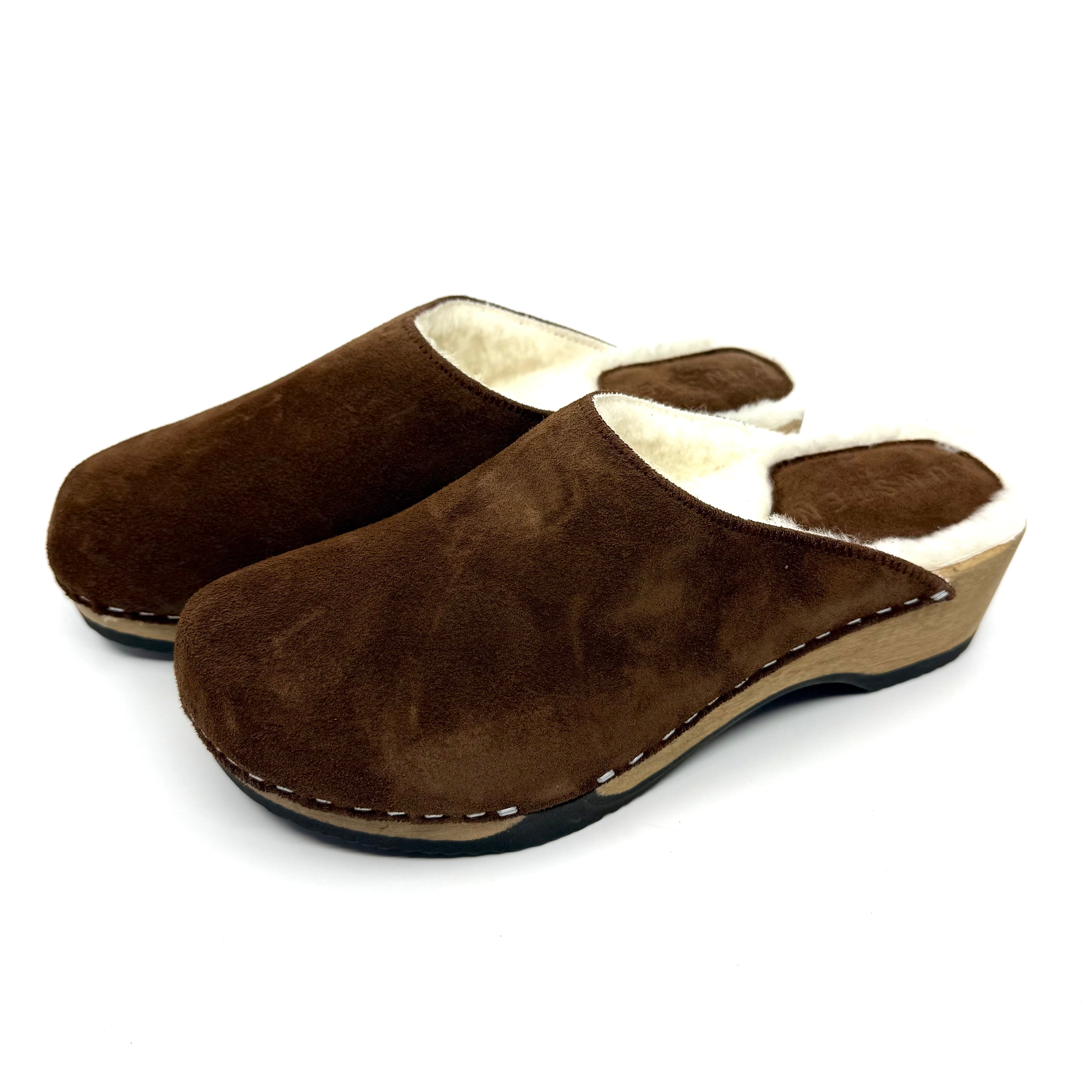 Pair of brown slippers with white lining on a white background