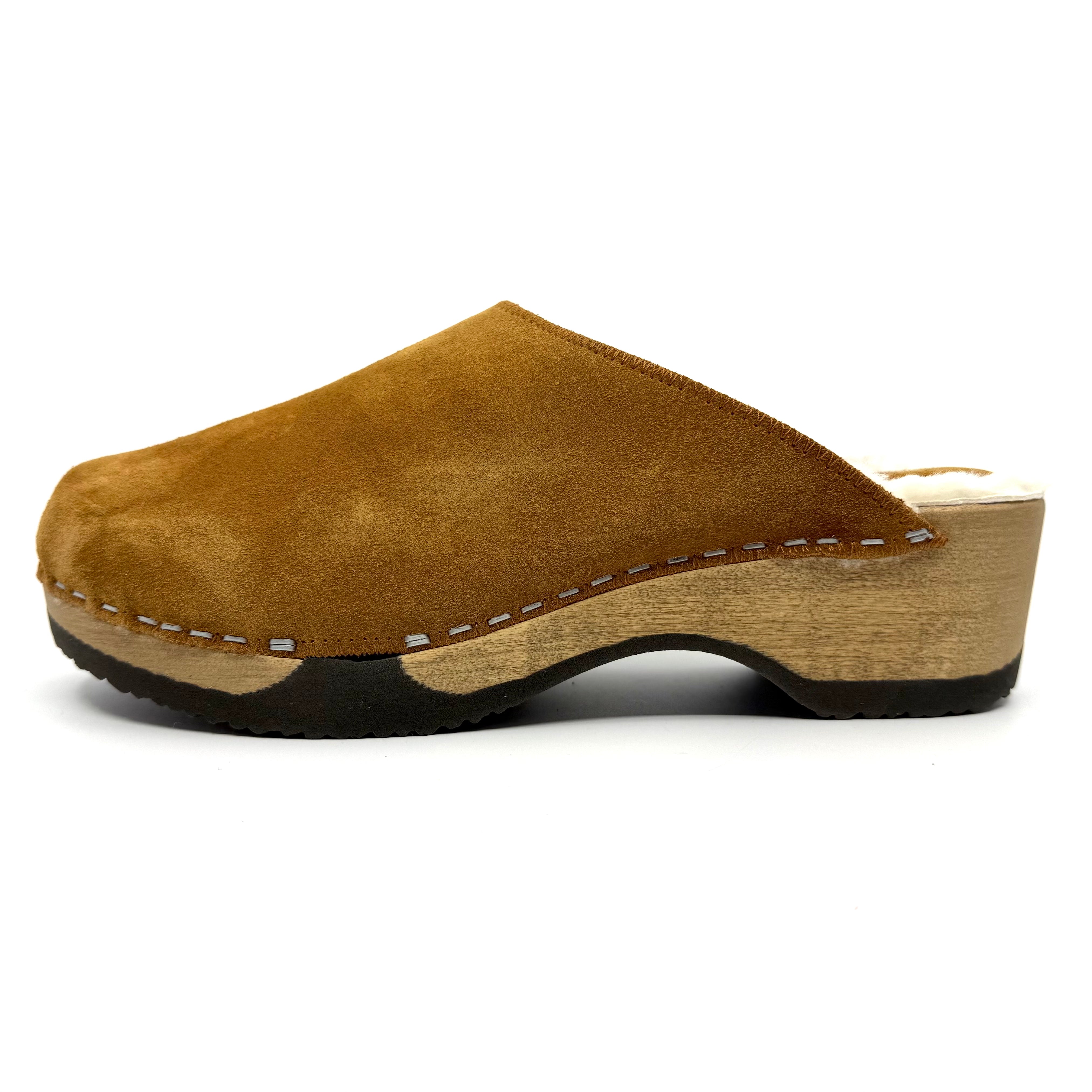 Brown suede clog shoe on a white background