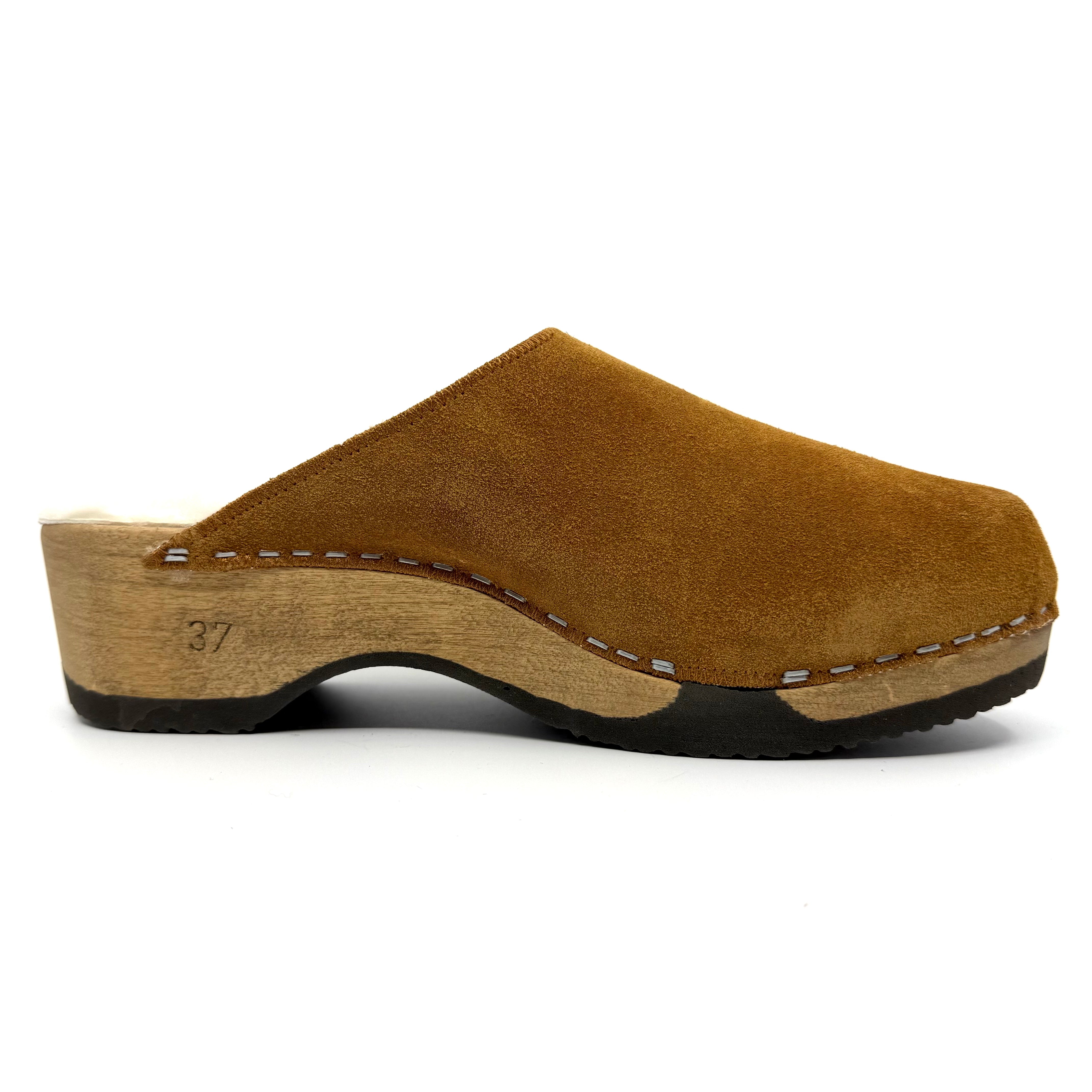 Brown suede clog shoe on a white background