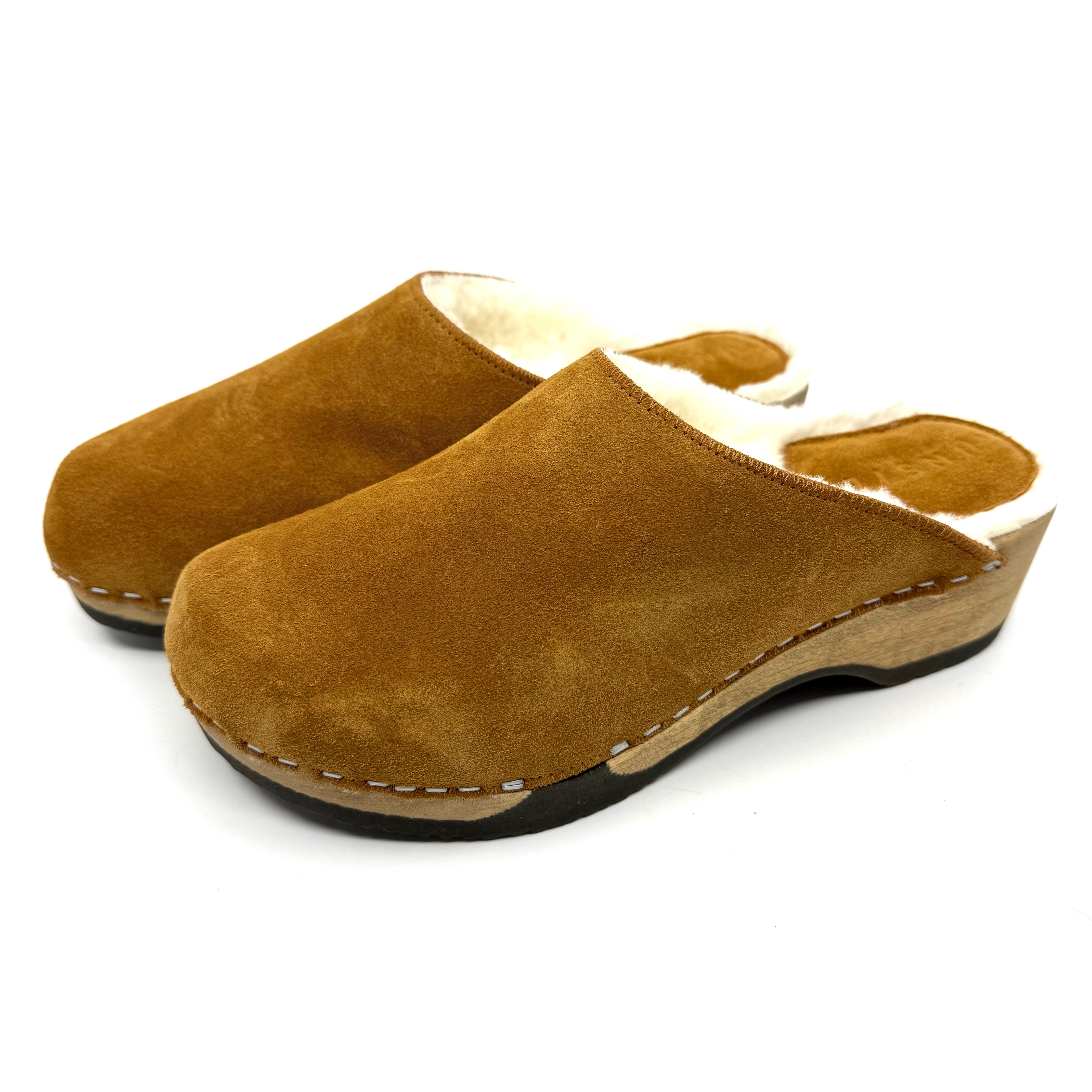 Pair of brown suede clogs on a white background