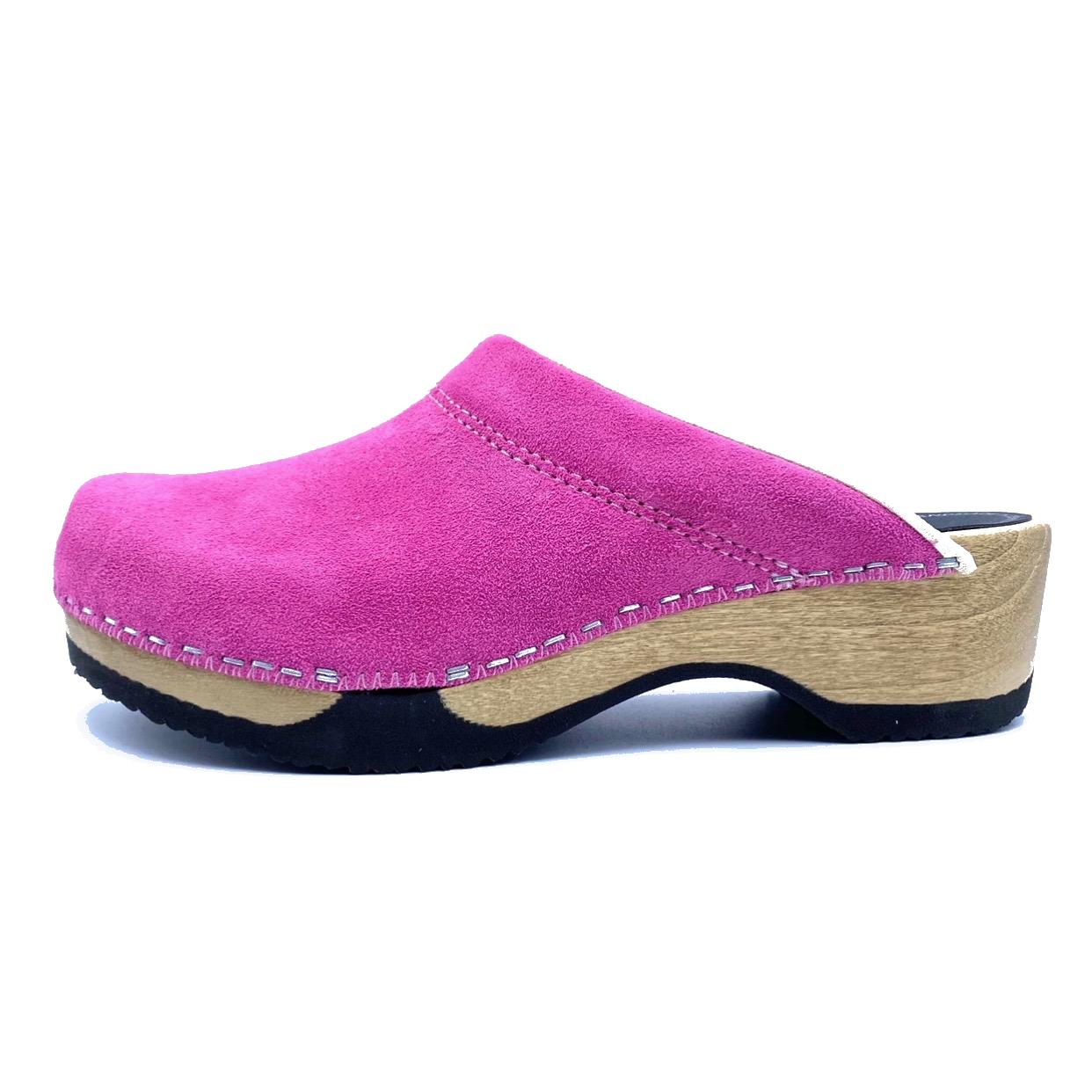 Pink clog shoe with wooden sole on a white background