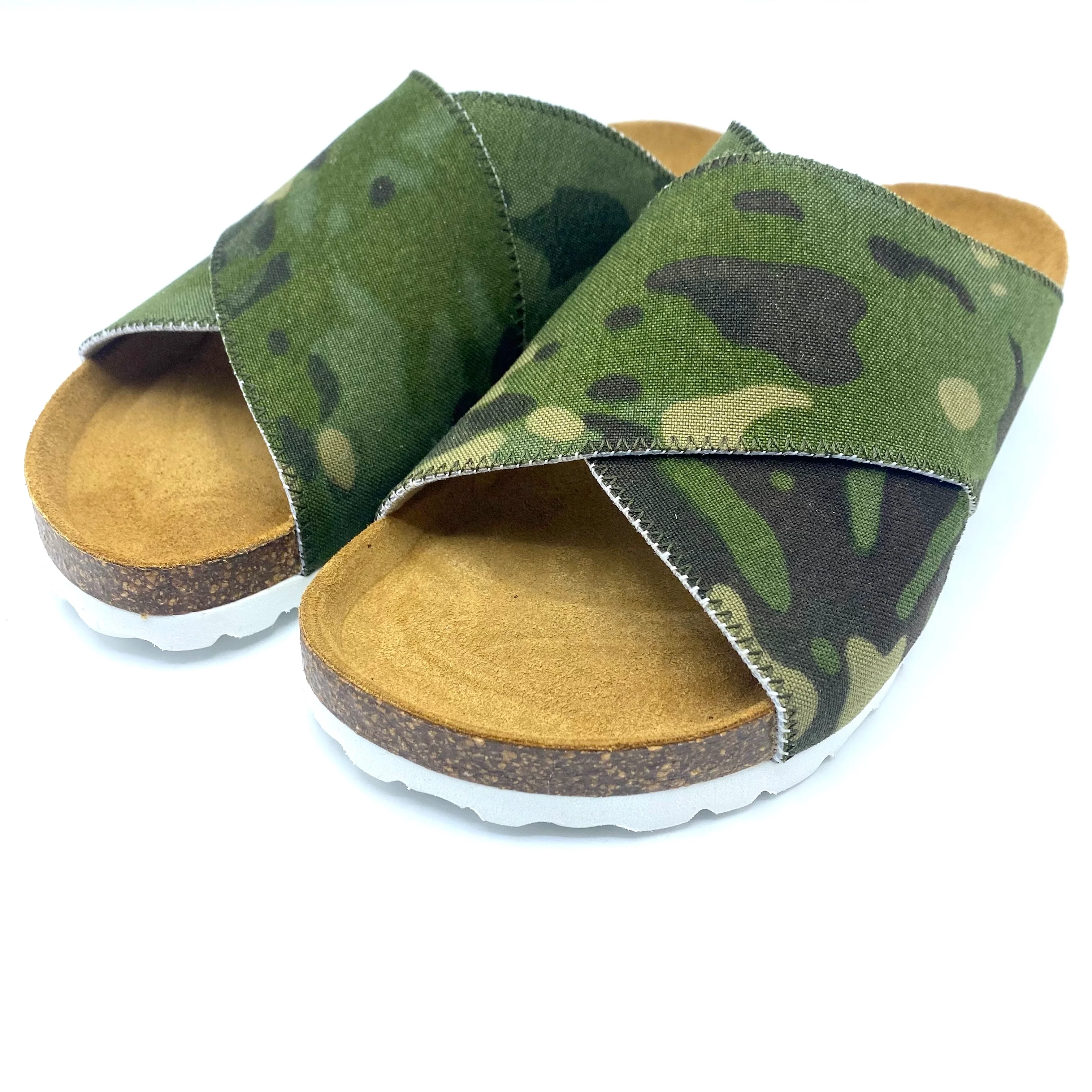 Camouflage-patterned sandals with cork soles on a white background