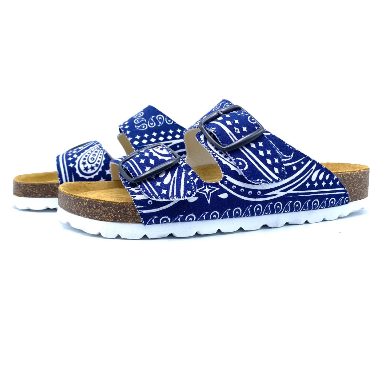 Pair of blue bandana-patterned sandals with cork soles on a white background