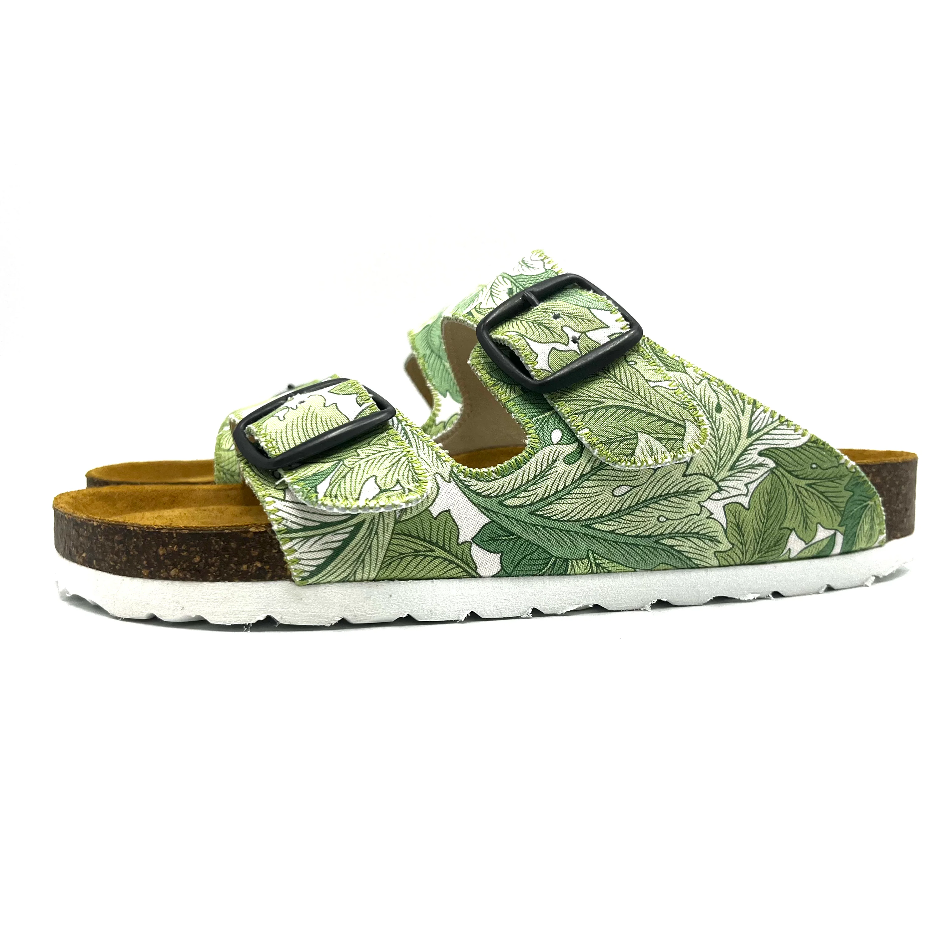 Green leaf-patterned sandal with black buckles on a white background
