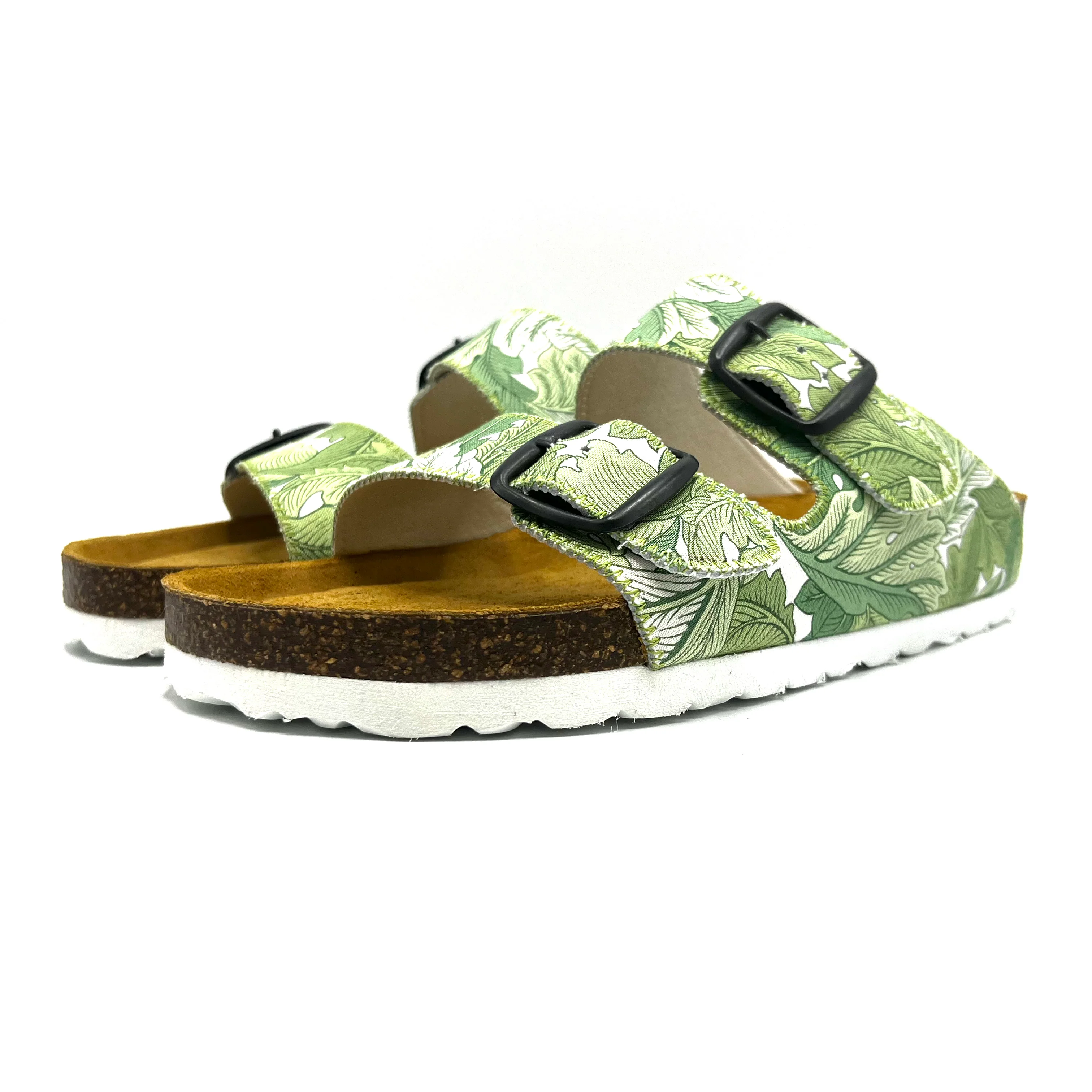 Green leaf-patterned sandals with cork sole on a white background