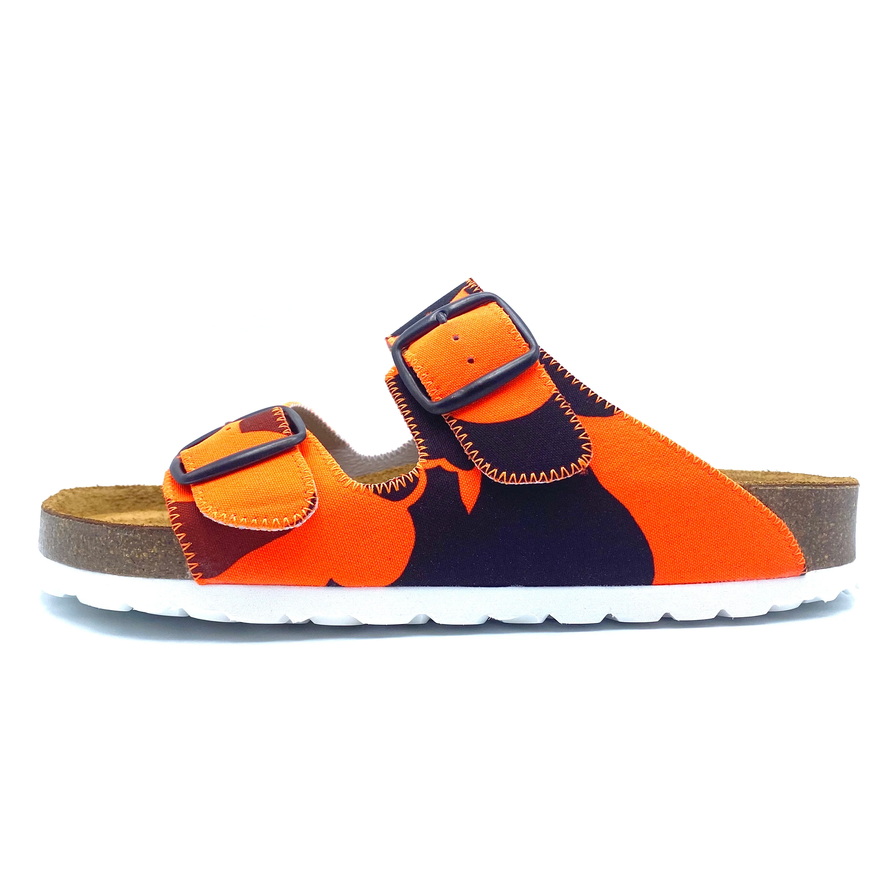 Orange and brown sandal with a white sole on a white background