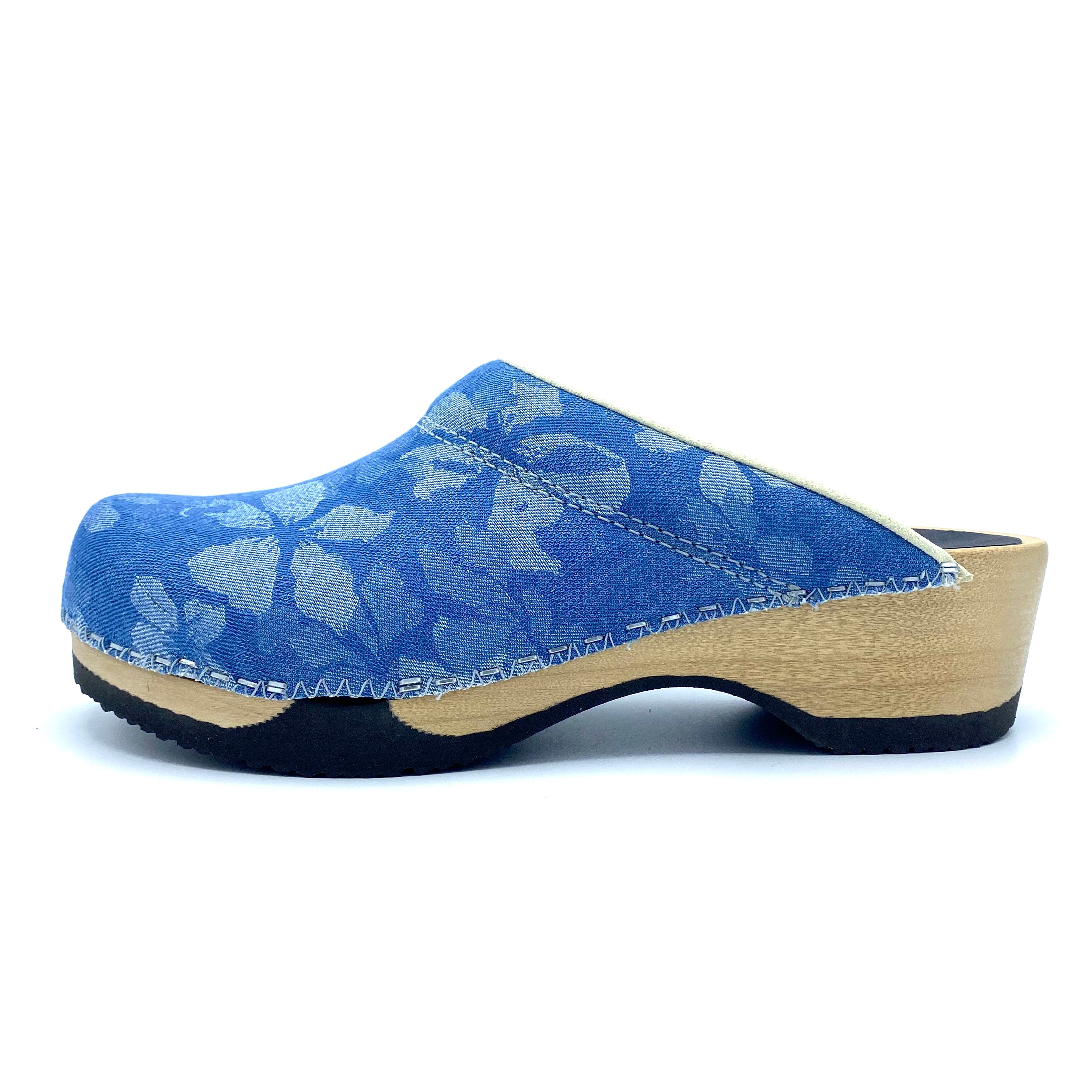 Blue floral-patterned clog shoe on a white background