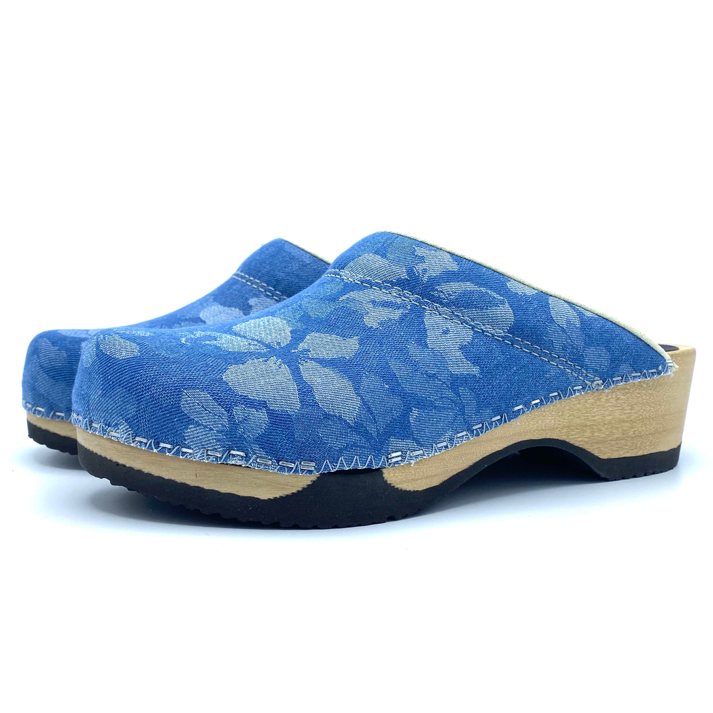 Blue floral-patterned clog shoe on a white background