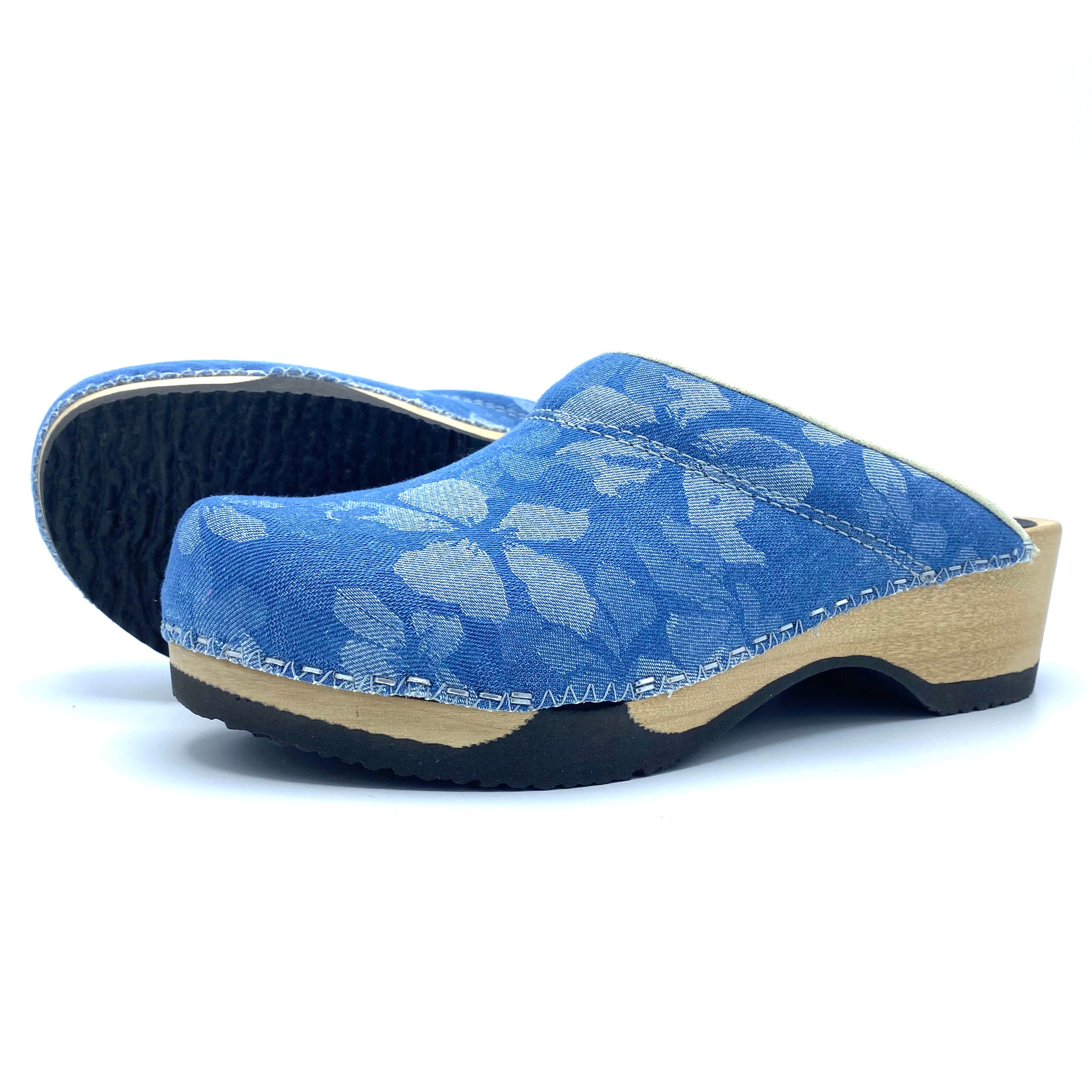 Blue floral-patterned clog shoe on a white background
