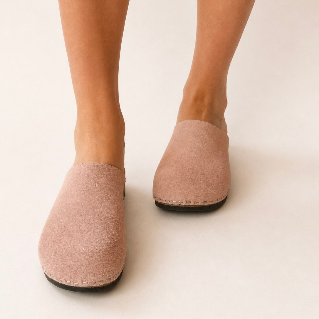 Pair of brown slippers on a white background